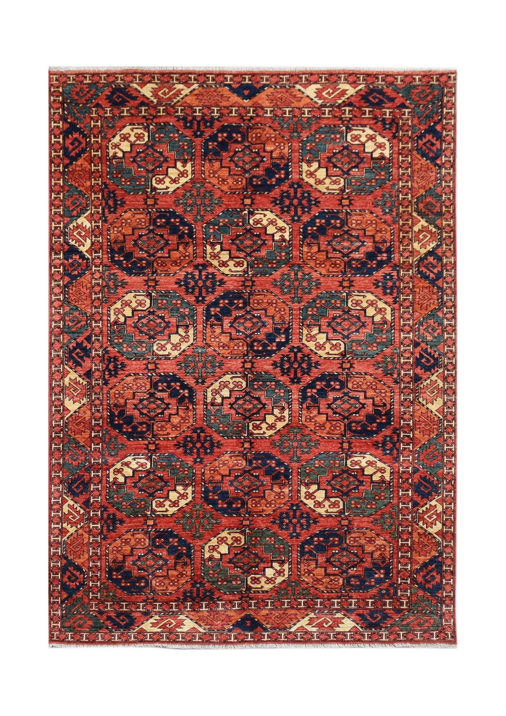 Handmade Afghan Chobi rug featuring a repeating geometric medallion pattern in red and blue tones.