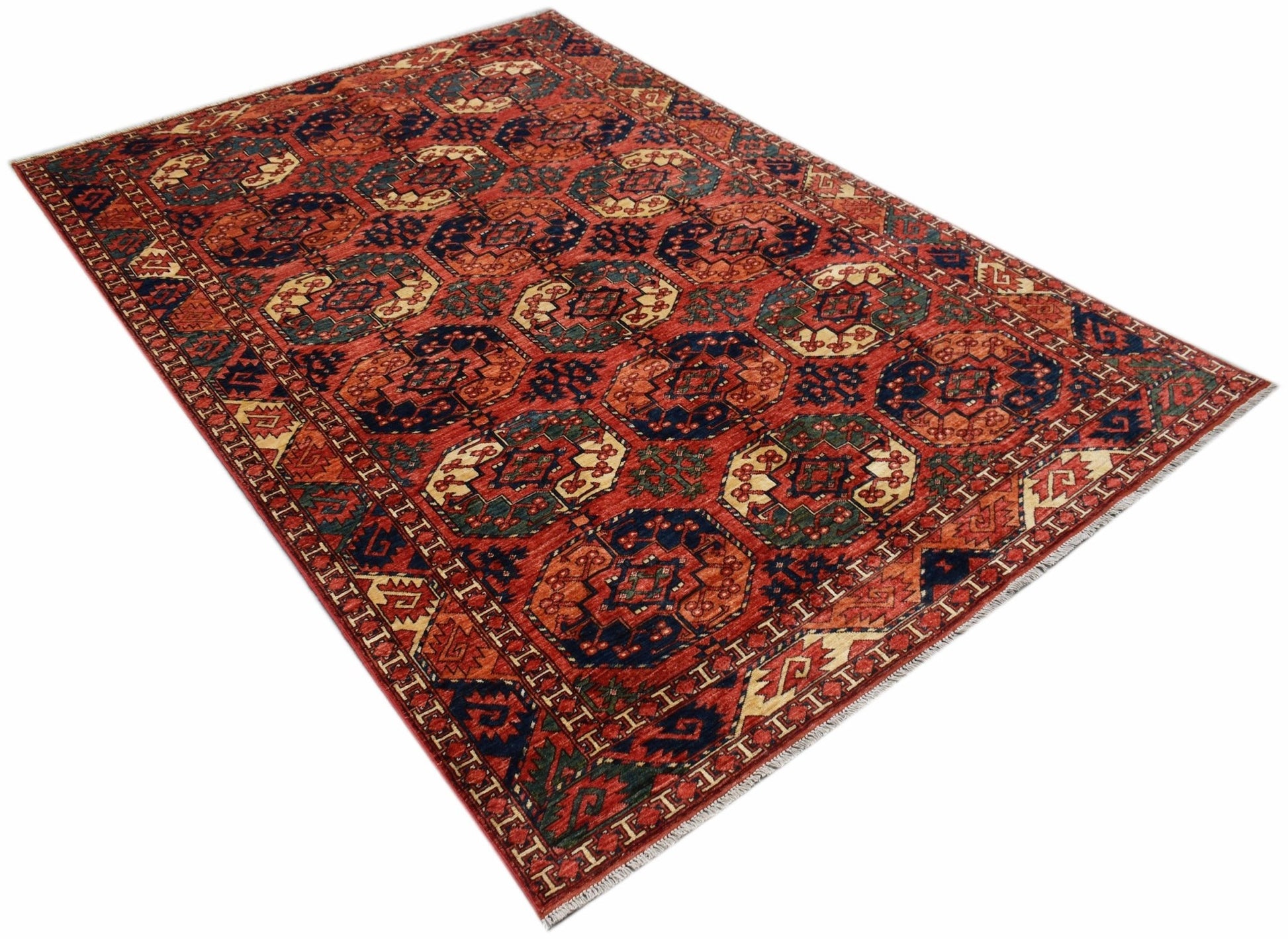 Handwoven Afghan Chobi rug featuring a repeating geometric pattern in red, blue, and cream tones.