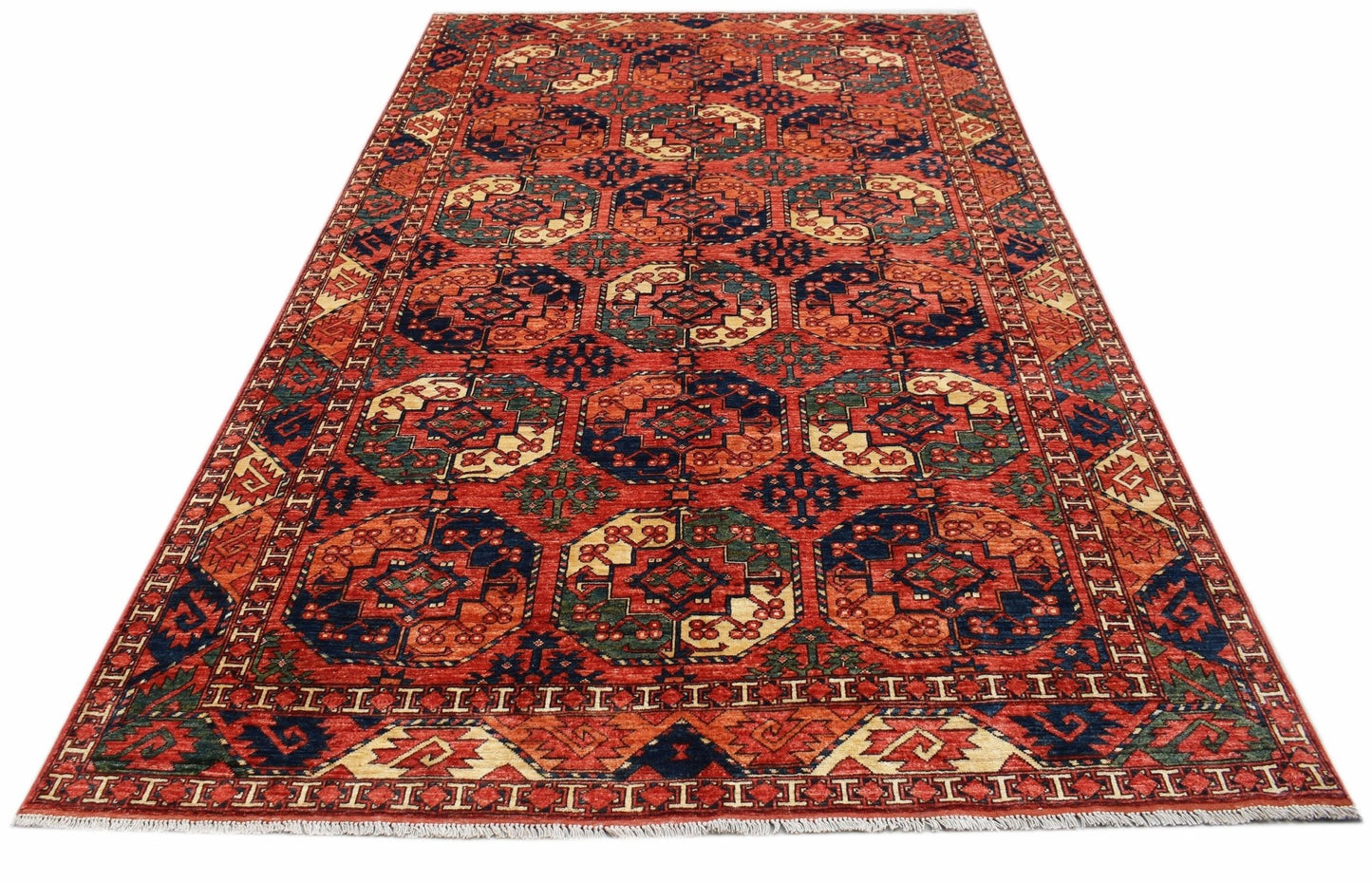 Handwoven Afghan Chobi rug featuring a geometric octagonal pattern in red, blue, and cream tones.