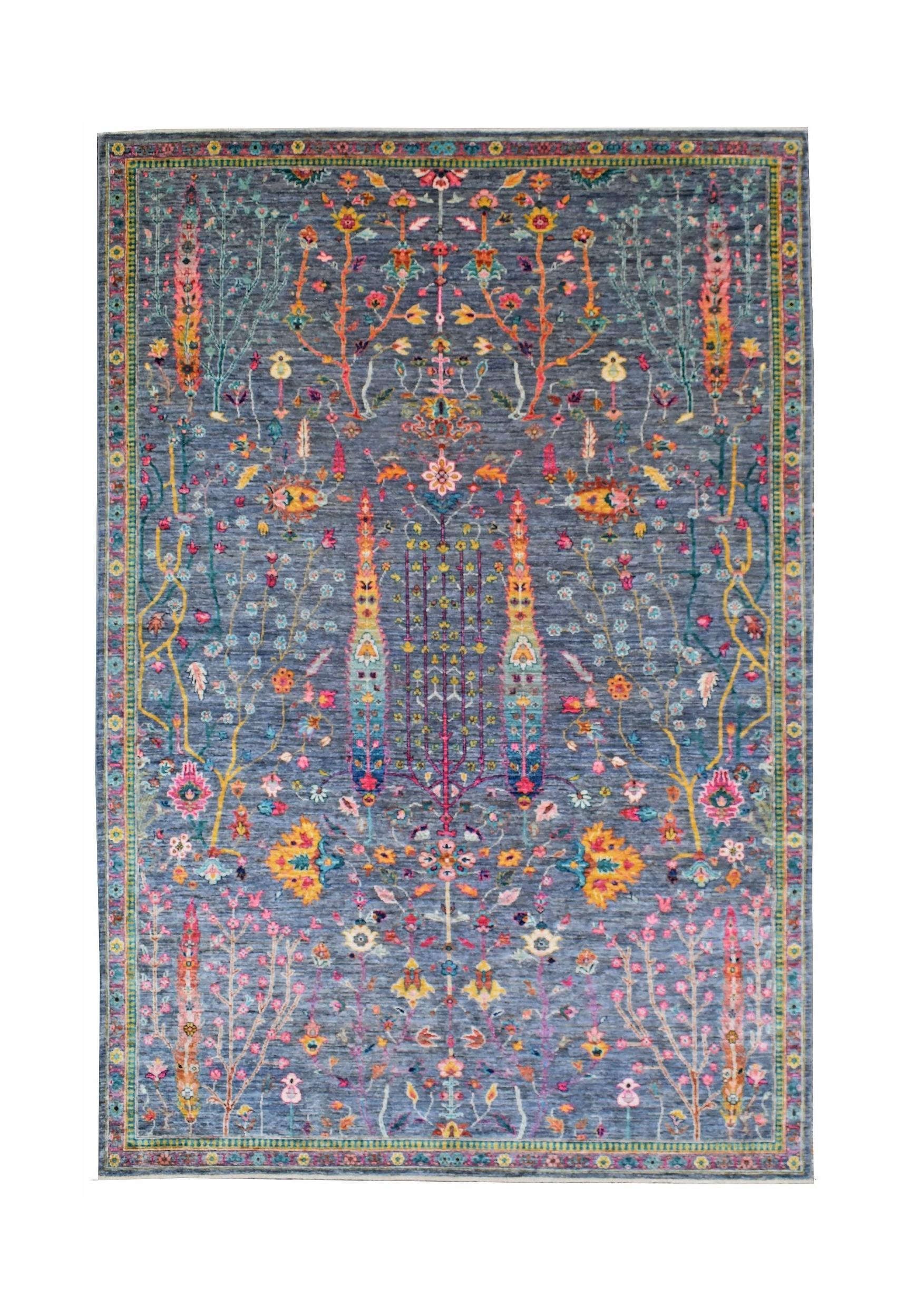 A rectangular Afghan Chobi rug featuring a blue field with intricate floral and tree motifs.
