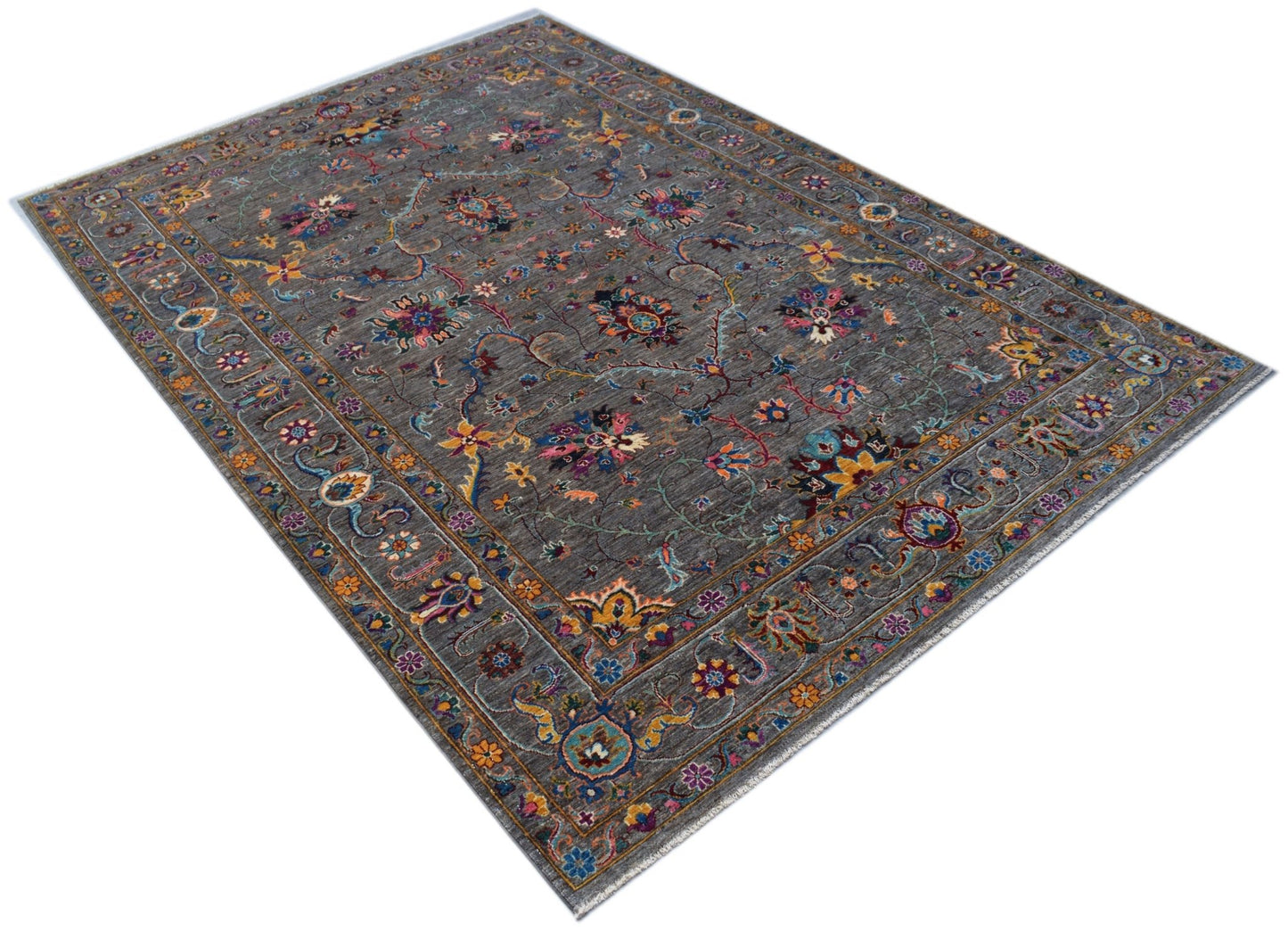 A rectangular Afghan Chobi rug featuring a grey field with intricate floral patterns.