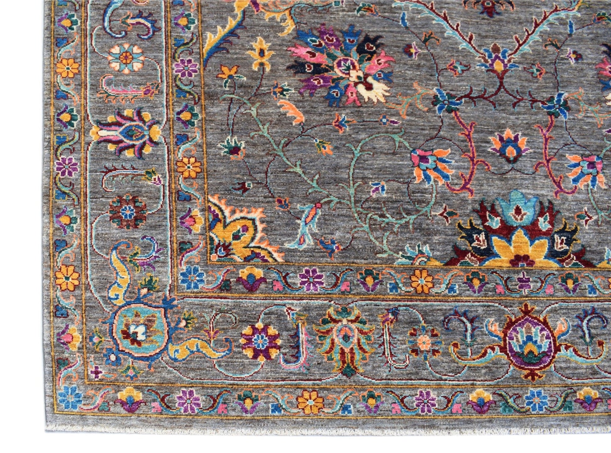 An Afghan Chobi rug featuring a grey field with intricate, colorful floral and vine patterns.