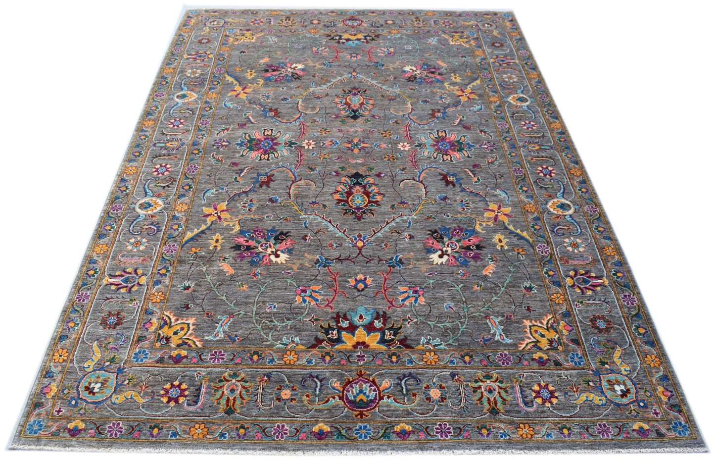 A handmade Afghan Chobi rug featuring a grey field with intricate floral patterns and a border.