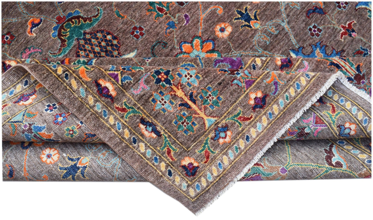 A handwoven Afghan Chobi rug featuring a brown field with colorful floral and vine patterns.
