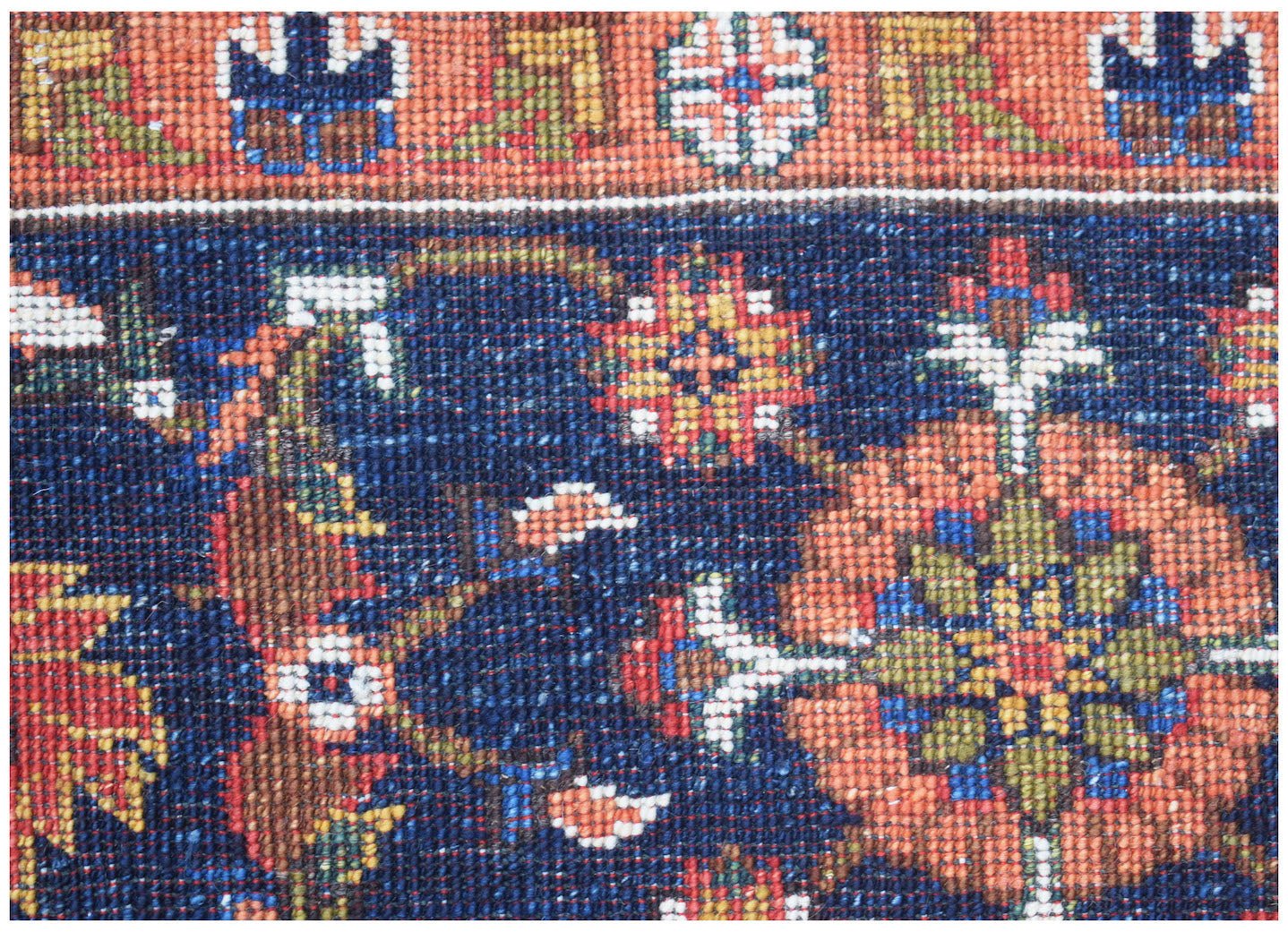 A close-up of a handmade Afghan Chobi rug featuring intricate floral patterns in earthy tones.