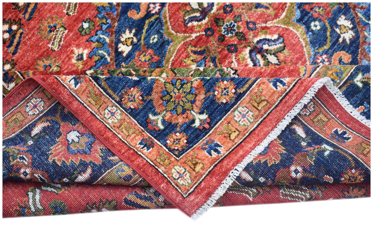 A handwoven Afghan Chobi rug featuring a traditional floral pattern in red and blue tones.