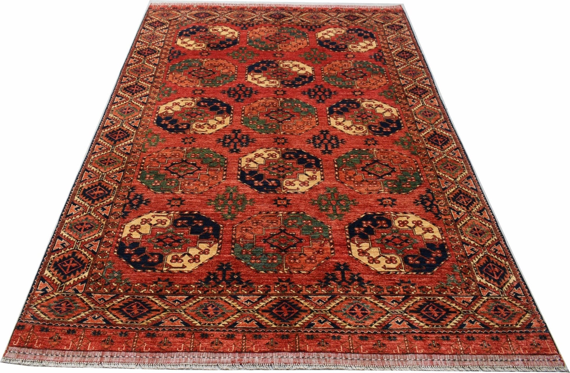 A handmade Afghan Chobi rug featuring a repeating octagonal pattern in warm, earthy tones.