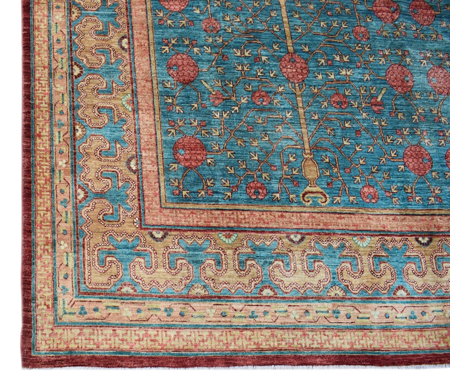 A handmade Afghan Balkh rug featuring a blue field with a pomegranate tree motif and ornate borders.