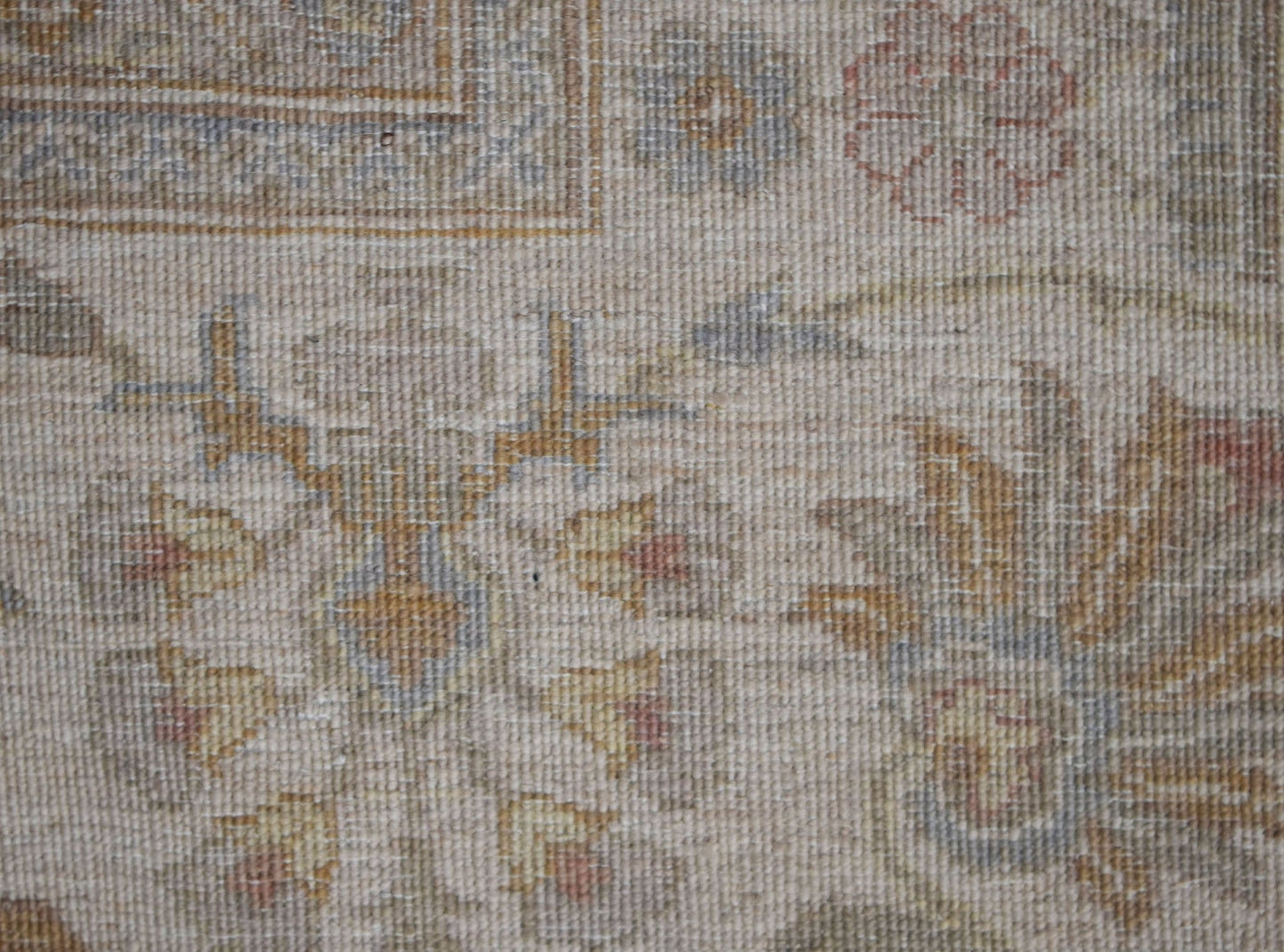 A close-up of an Afghan Chobi rug featuring traditional floral patterns in soft, earthy tones.