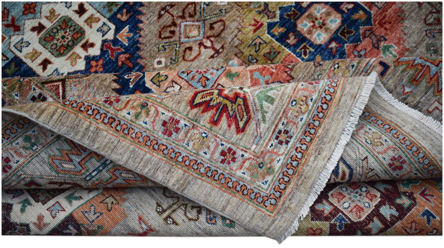 A handwoven Afghan Chobi rug featuring intricate geometric patterns in earthy, muted tones.