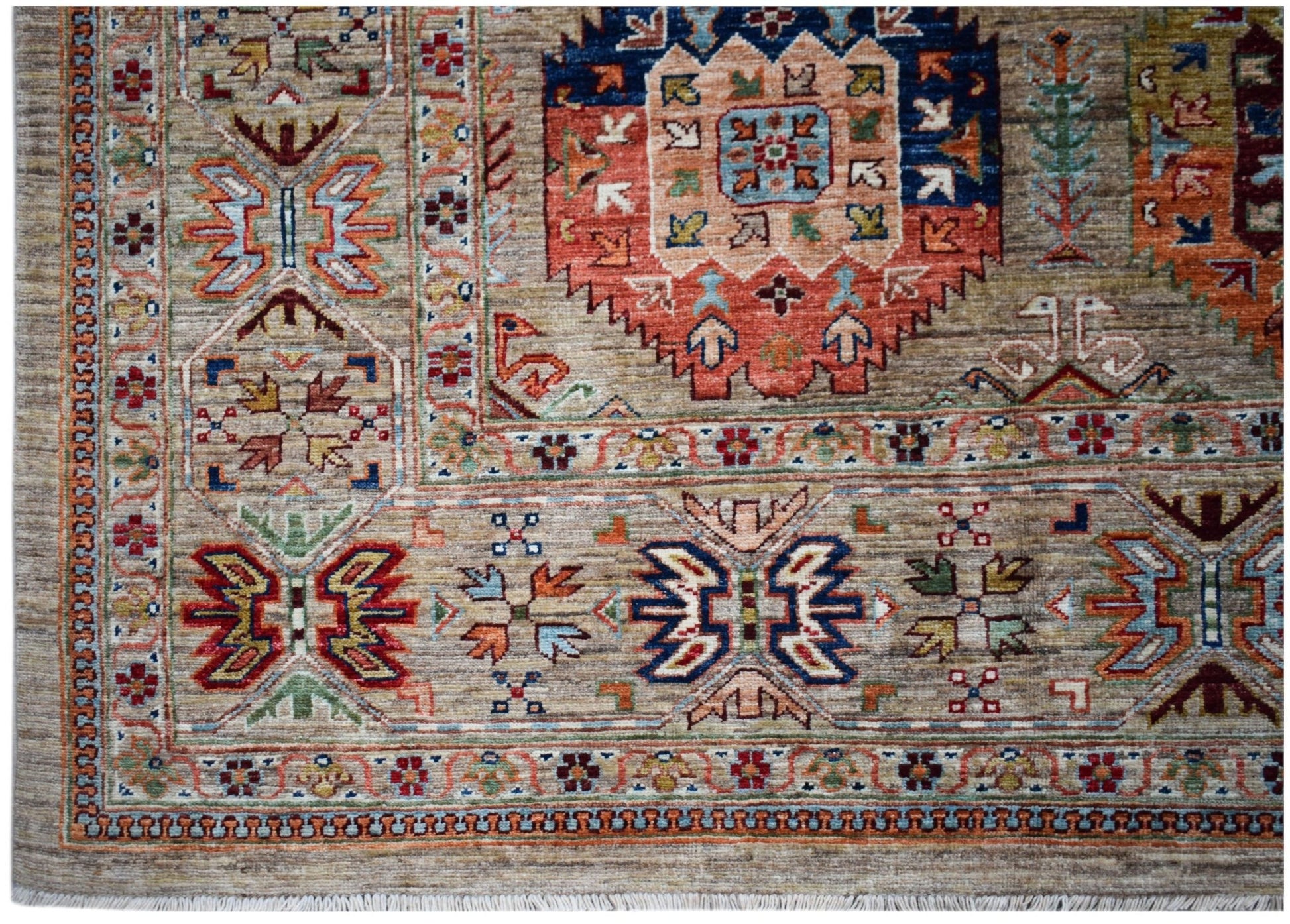 Handwoven Afghan Chobi rug featuring intricate geometric patterns in earthy, muted tones.