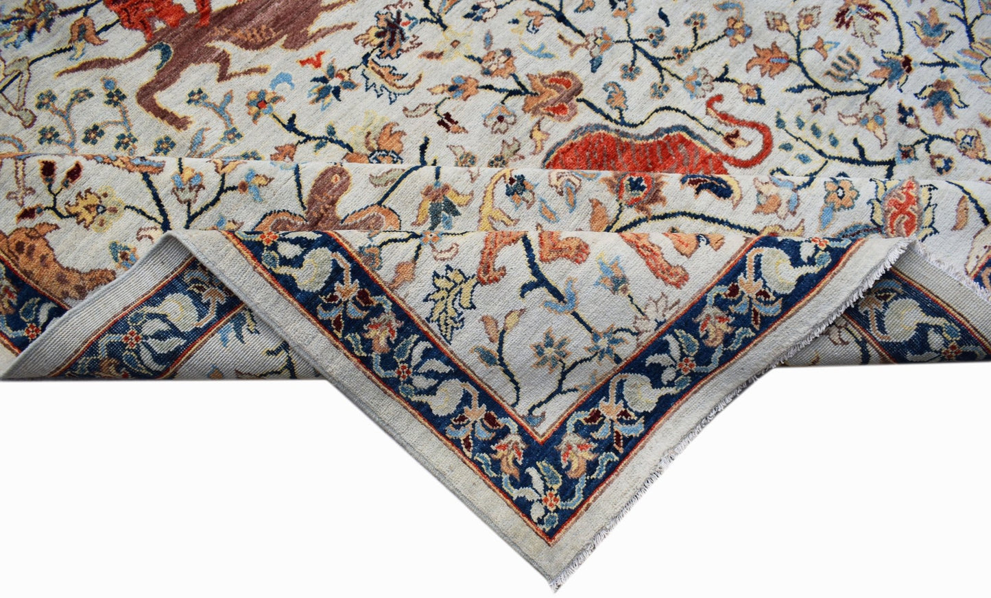 Handwoven Afghan Chobi rug featuring a traditional hunting scene with a blue floral border.