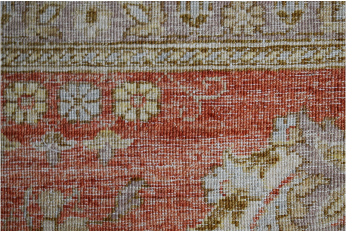 A close-up of a handwoven Afghan Chobi rug featuring traditional floral patterns in earthy tones.