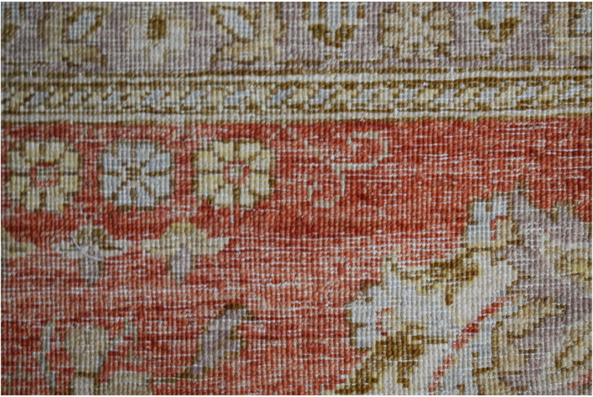 A close-up of a handwoven Afghan Chobi rug featuring traditional floral patterns in earthy tones.