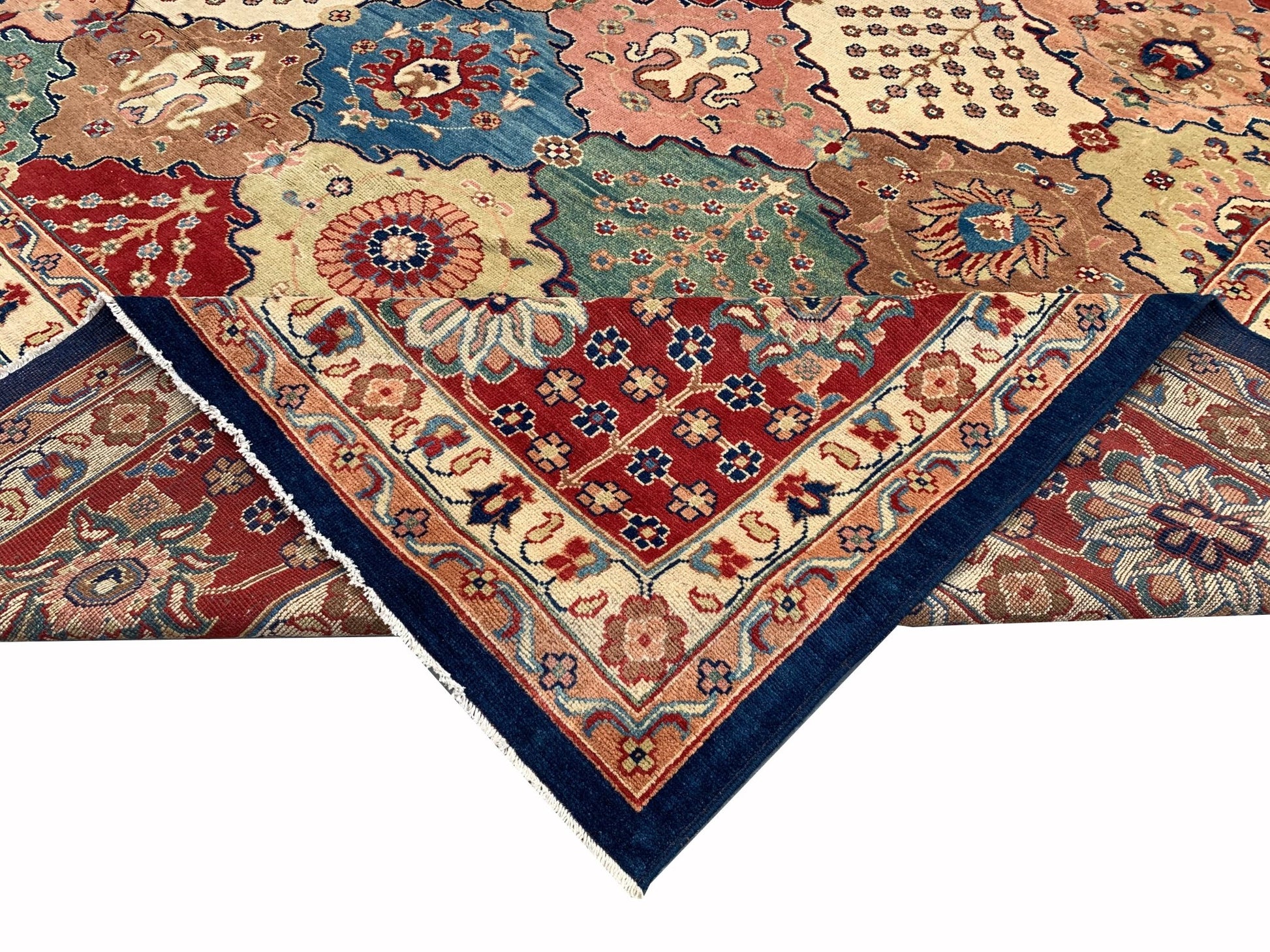 A handmade Afghan Chobi rug featuring a colorful geometric pattern with a folded corner.