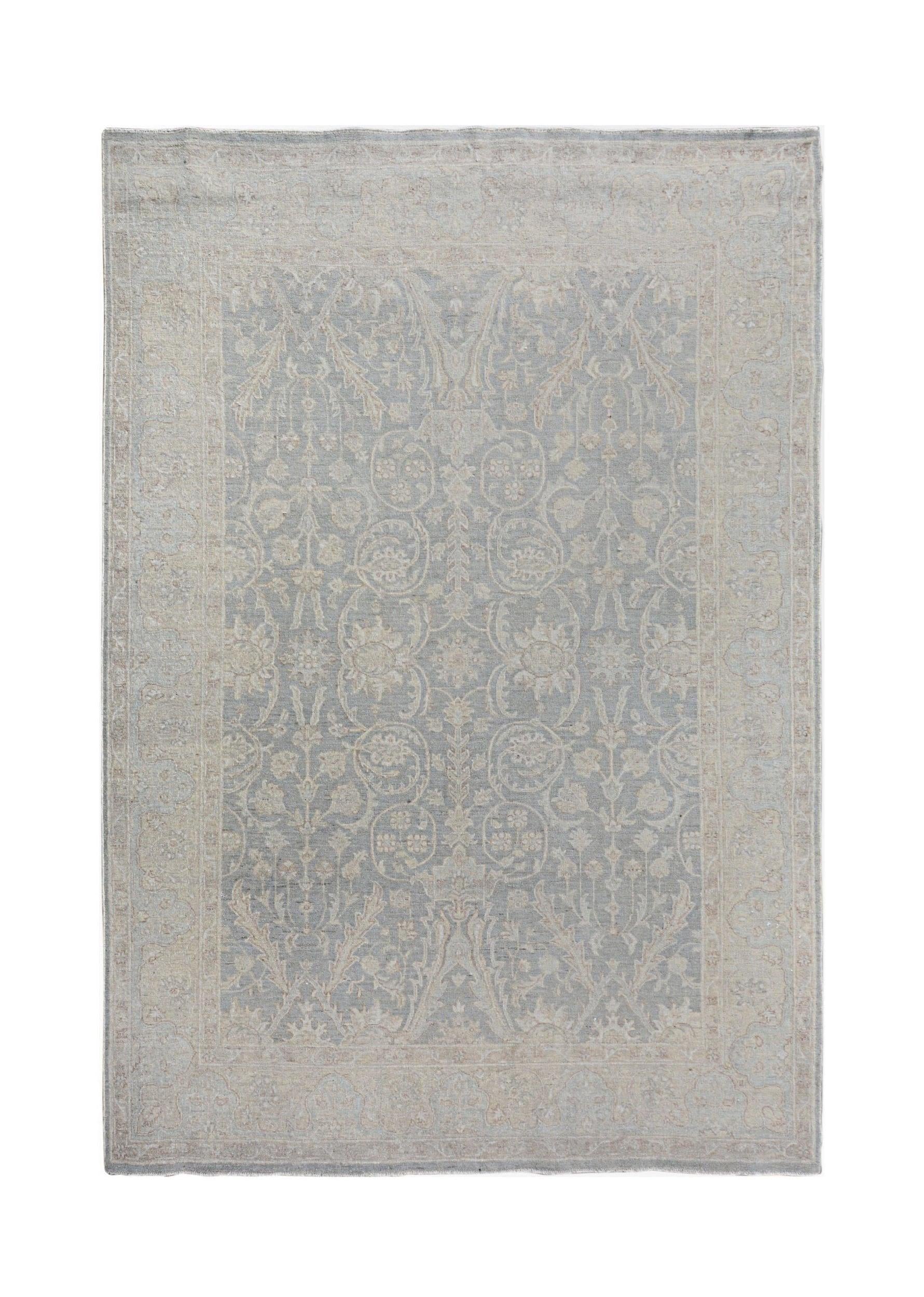 An Afghan Chobi rug featuring a traditional floral pattern in soft blue and beige tones.