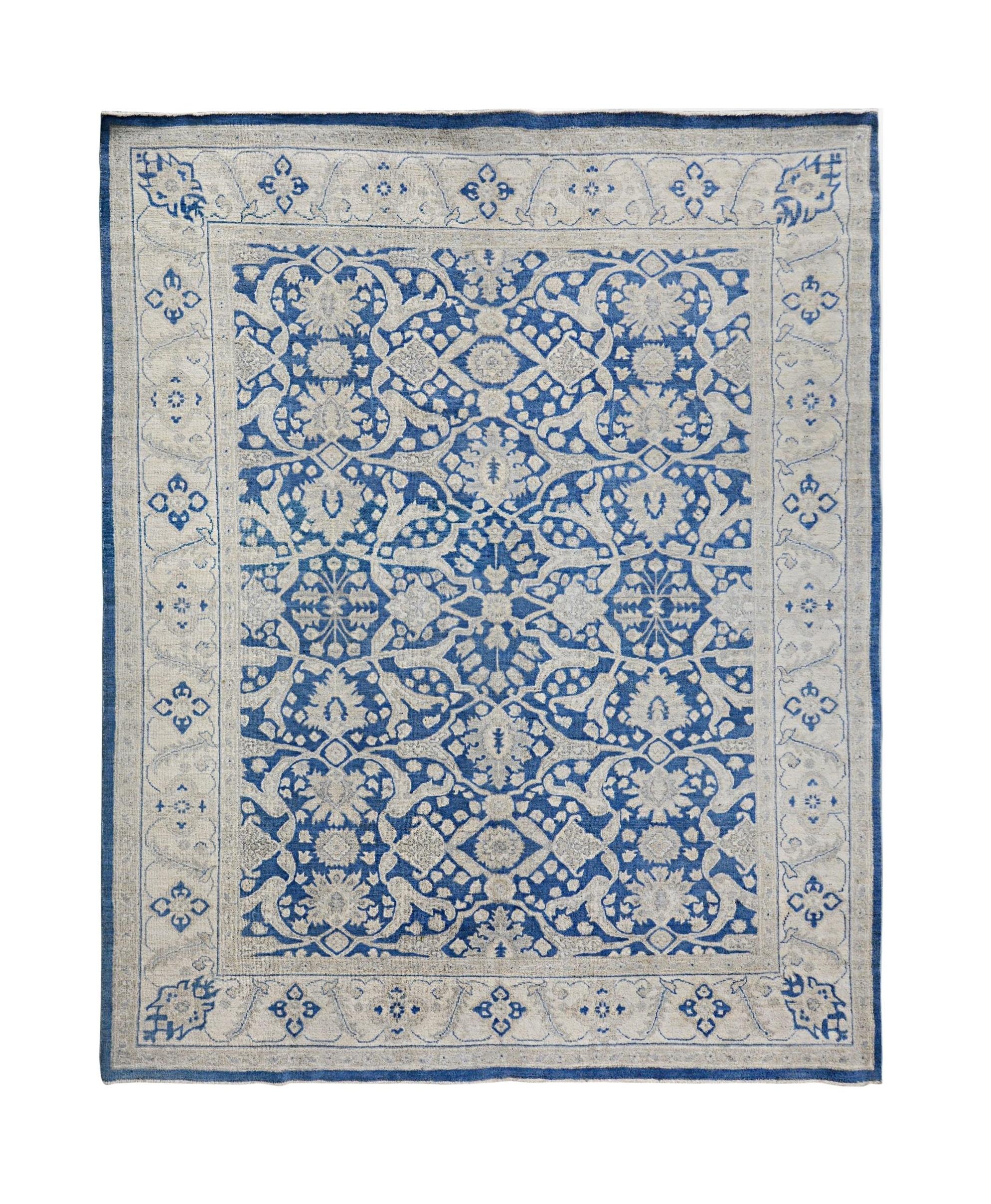 Handmade Afghan Chobi rug featuring a traditional blue and cream floral pattern.
