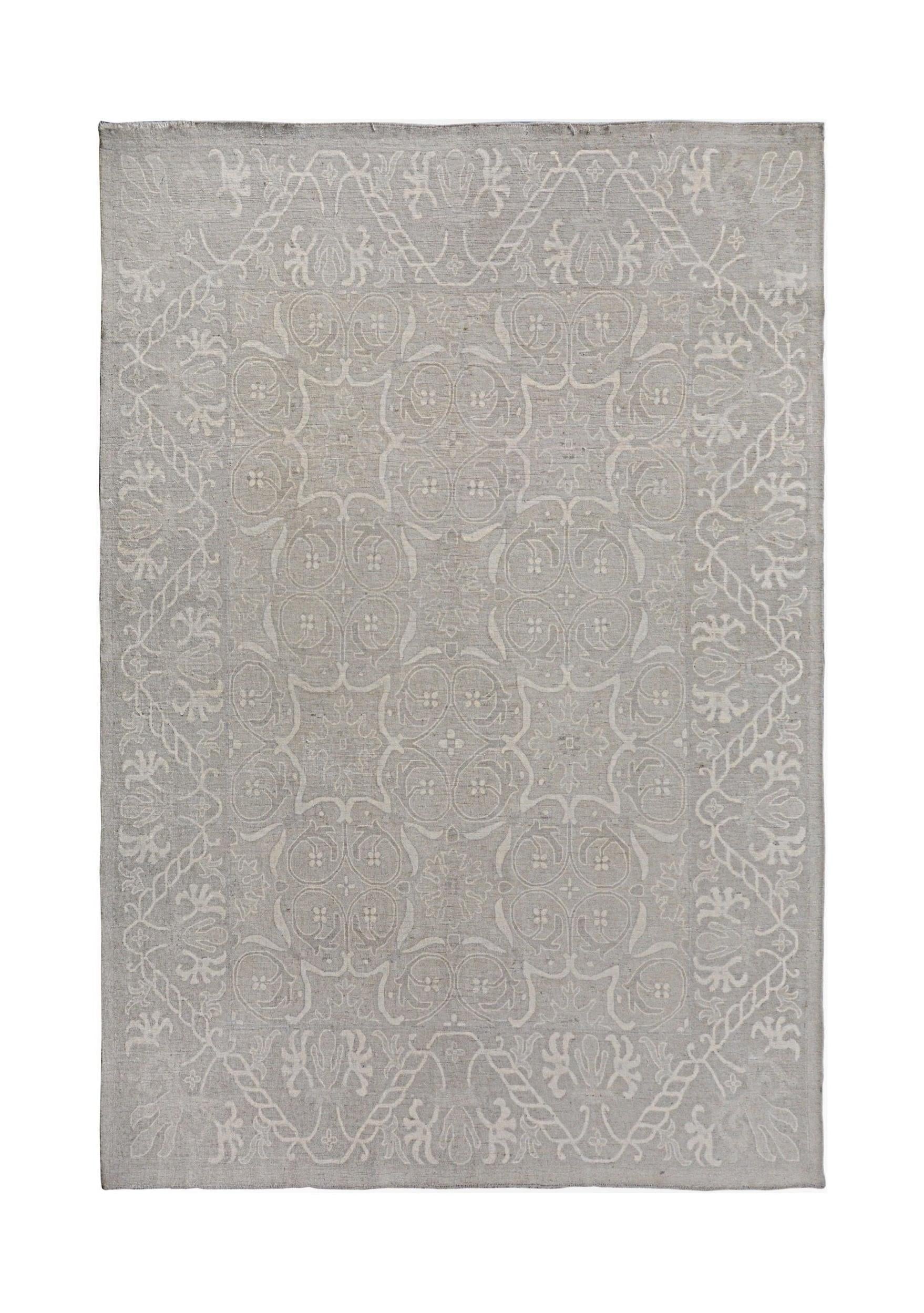 A handmade Afghan Chobi rug featuring a light grey floral pattern on a neutral background.