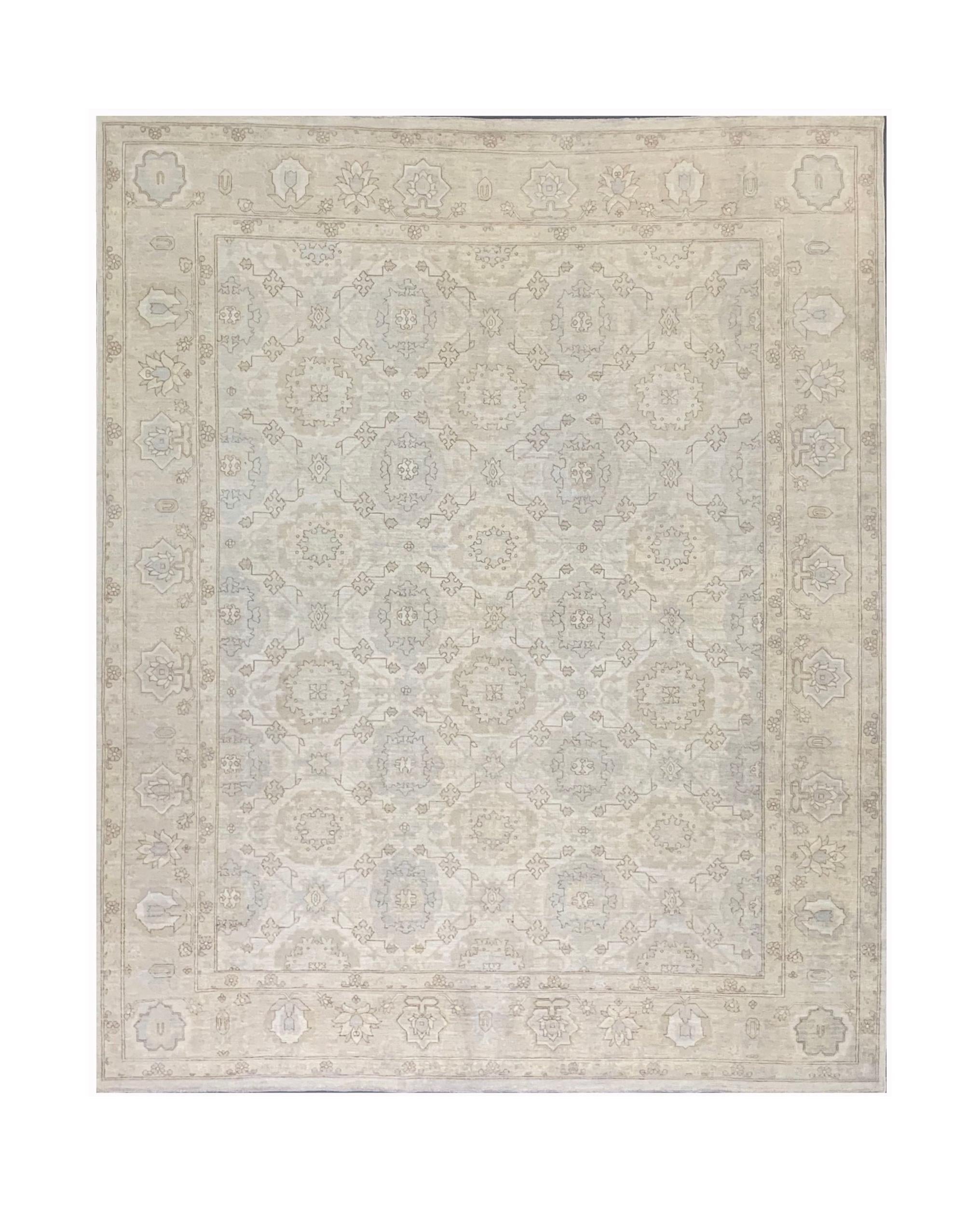 A handmade Afghan Chobi rug featuring a traditional floral pattern in soft neutral tones.