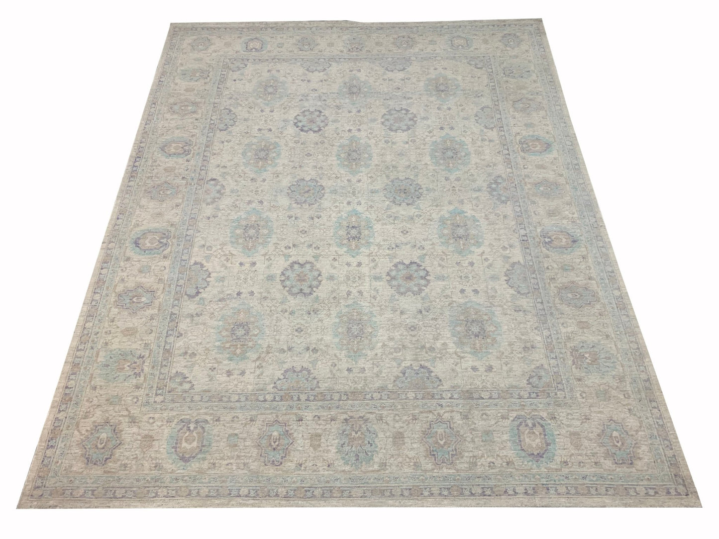 A handmade Afghan Chobi rug featuring a traditional floral pattern in soft beige and blue tones.