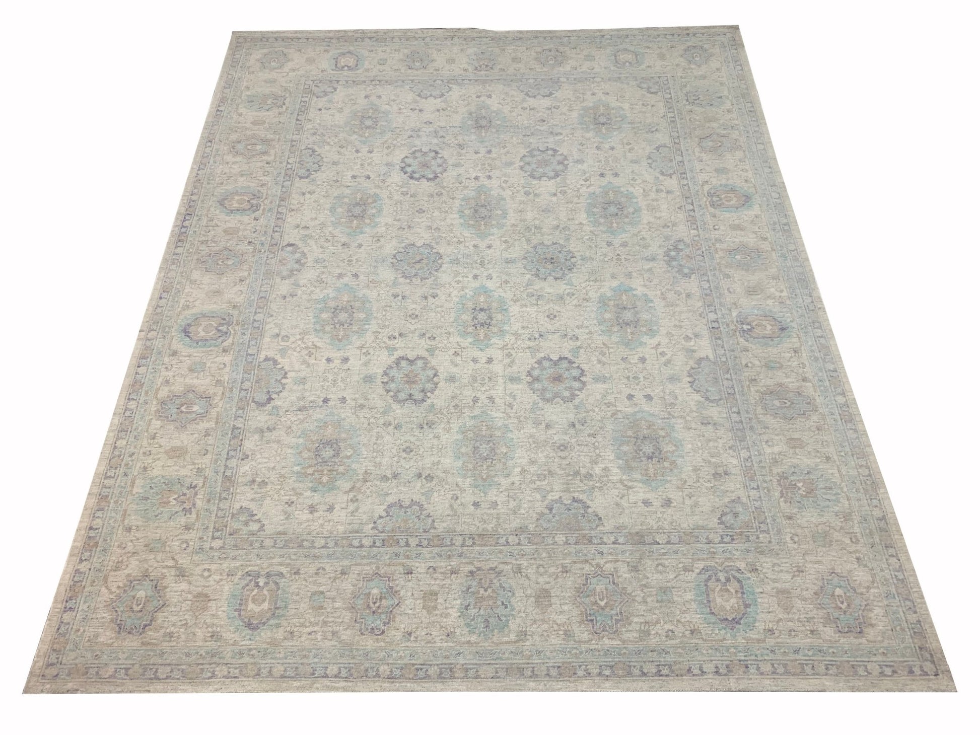A handmade Afghan Chobi rug featuring a traditional floral pattern in soft beige and blue tones.