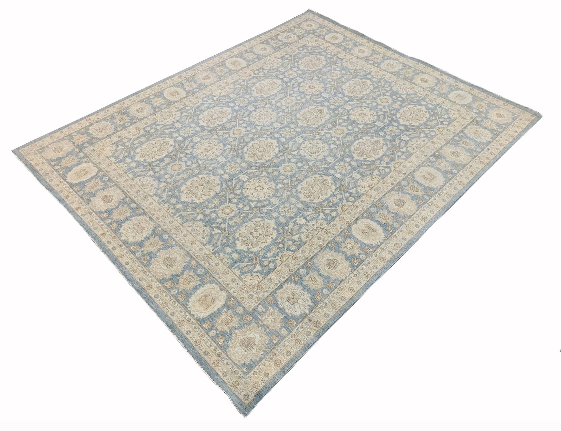A handmade Afghan Chobi rug featuring a traditional floral pattern in soft blue and beige tones.