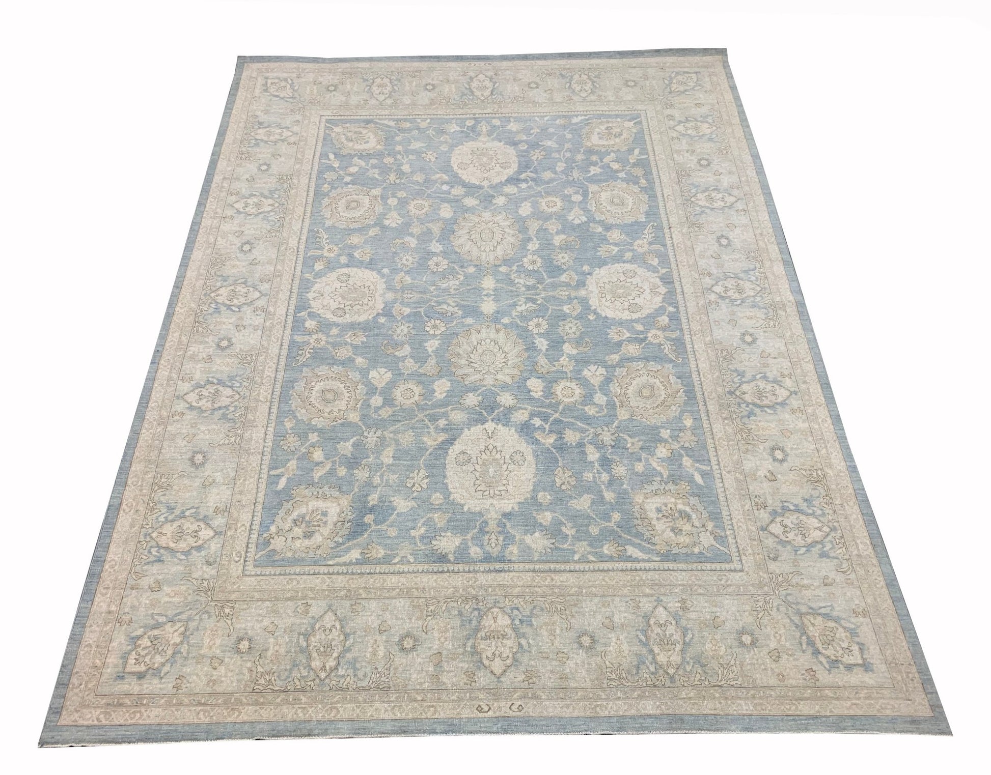 A handmade Afghan Chobi rug featuring a traditional floral pattern in shades of blue and beige.