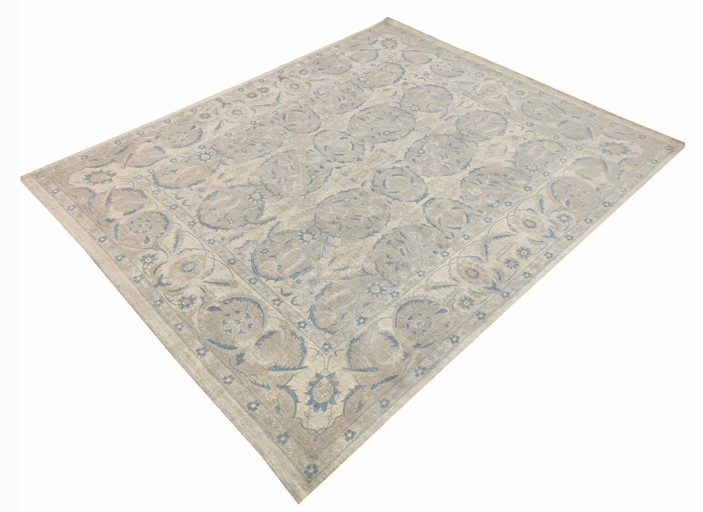 A handmade Afghan Balkh rug featuring a traditional floral pattern in soft blue and beige tones.
