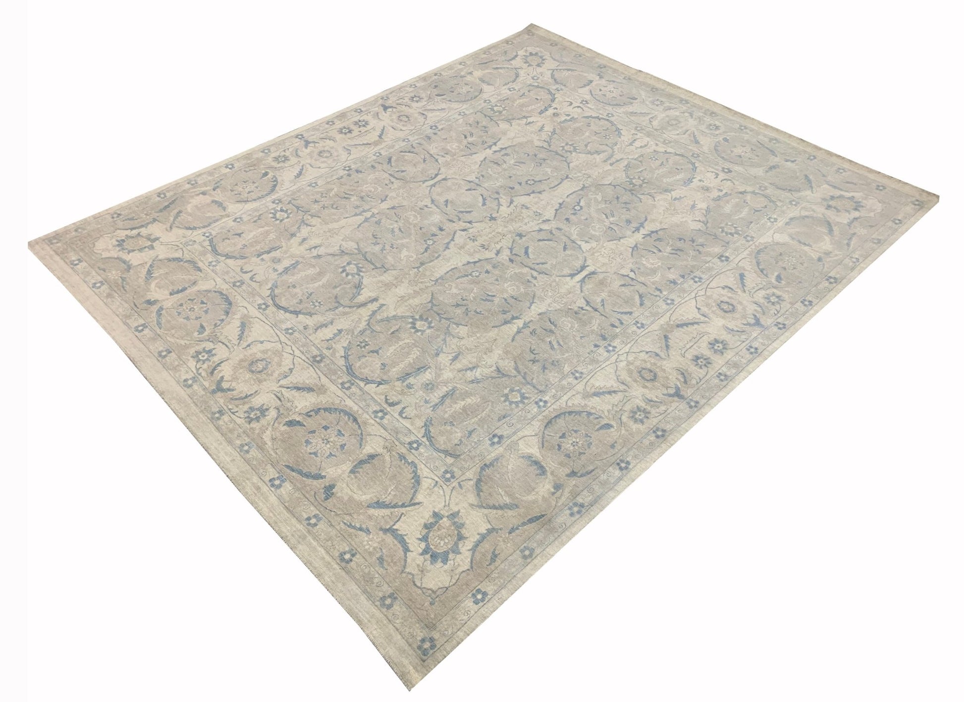 A handmade Afghan Balkh rug featuring a traditional floral pattern in soft blue and beige tones.