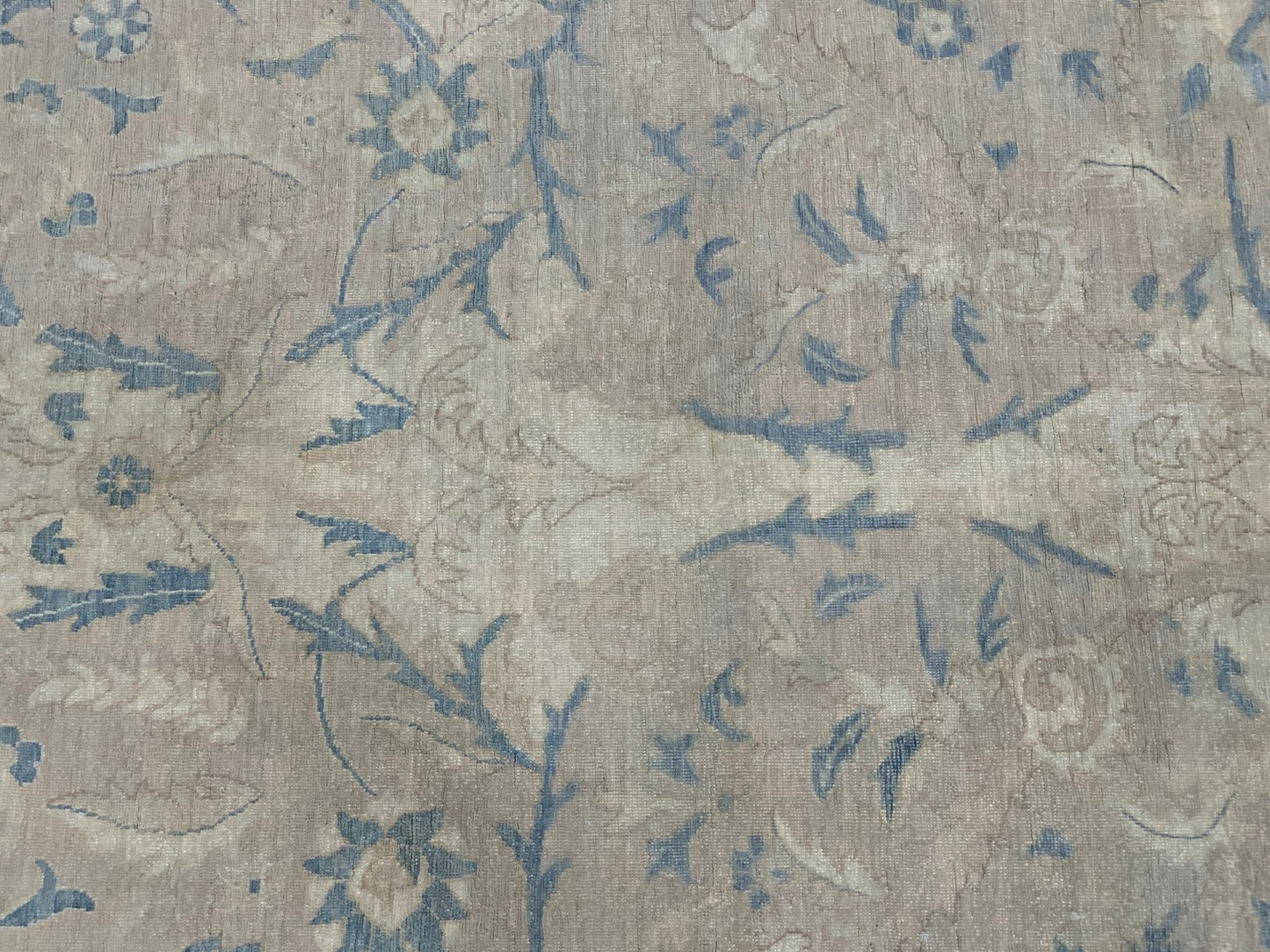 A handmade Afghan Balkh rug featuring a traditional floral pattern in muted blue and beige tones.