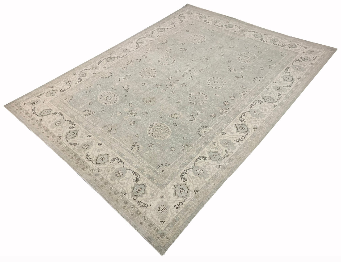 An Afghan Balkh rug featuring a traditional floral pattern in soft grey and beige tones.