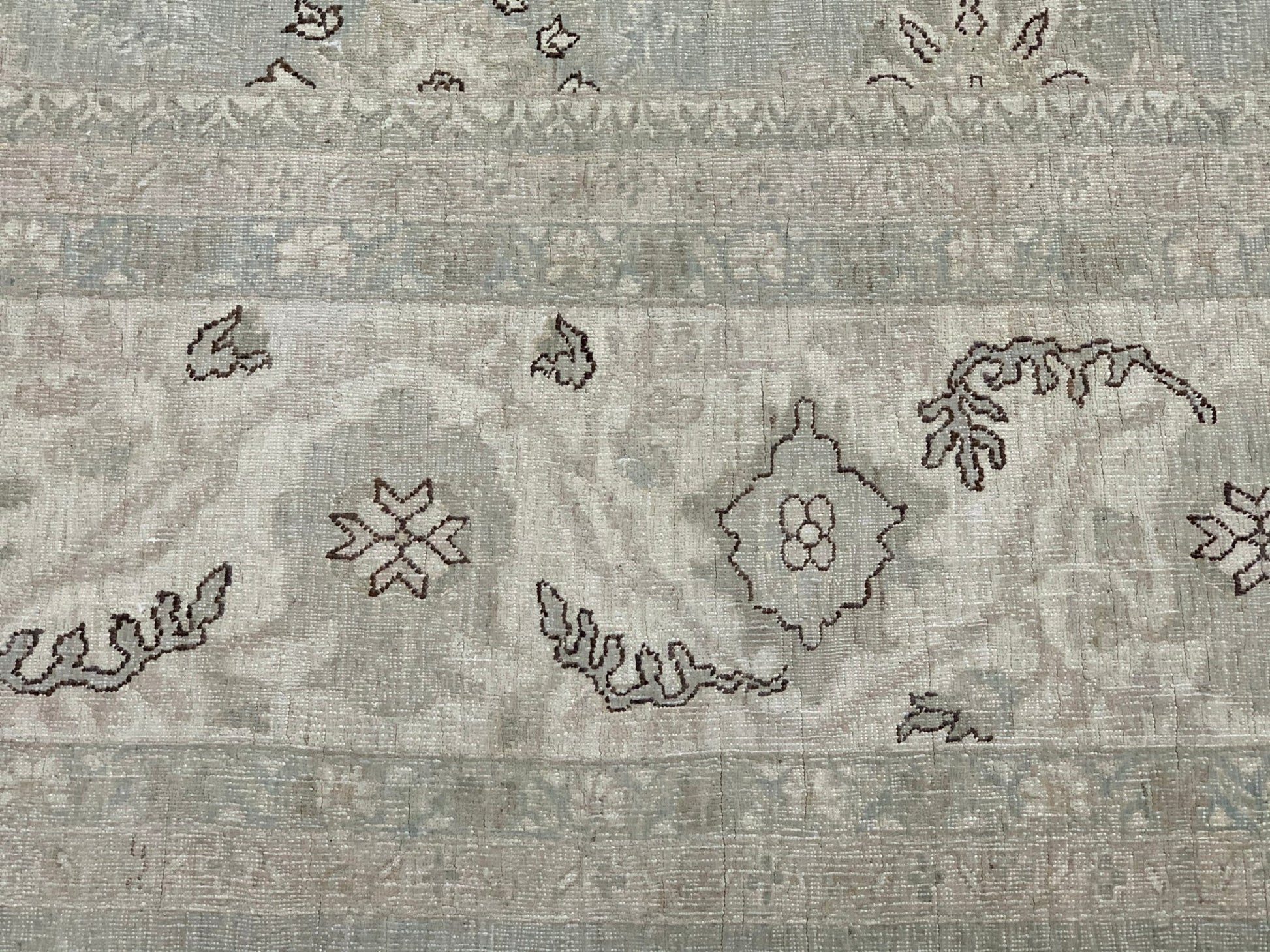 A handmade Afghan Balkh rug featuring a neutral palette with traditional floral and geometric motifs.