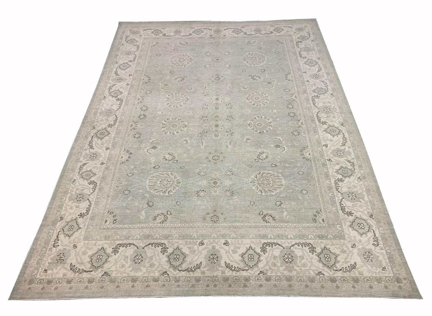 A handmade Afghan Balkh rug featuring a traditional floral pattern in soft grey and beige tones.