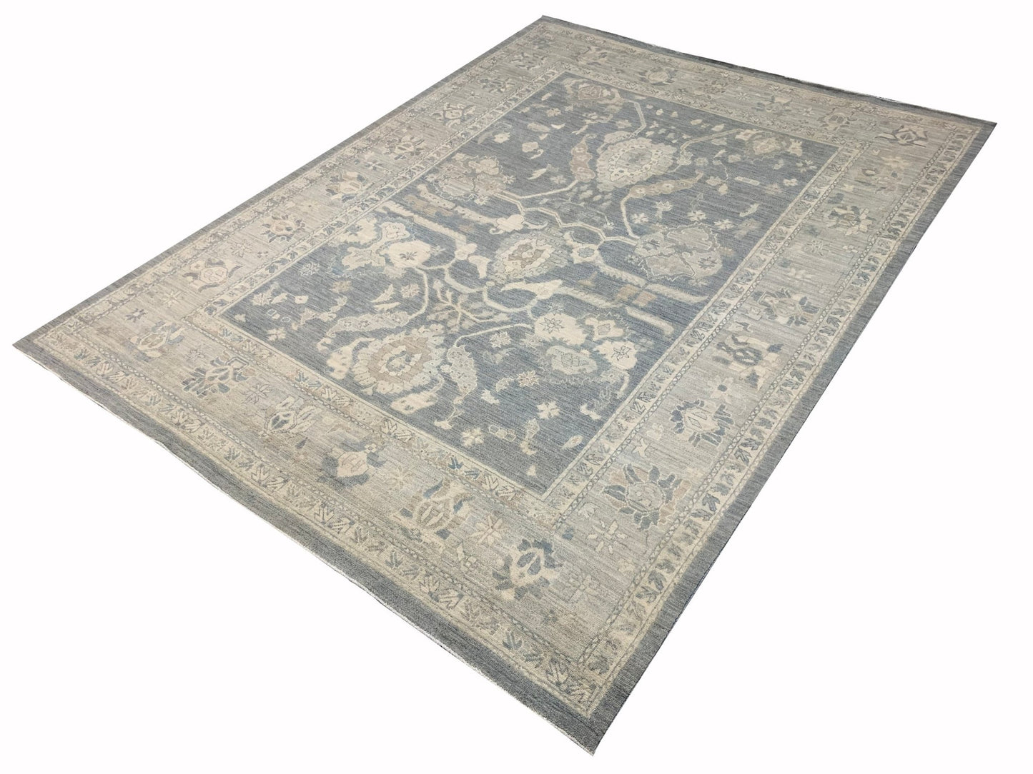 An Afghan Chobi rug featuring a traditional floral pattern in shades of blue and beige.