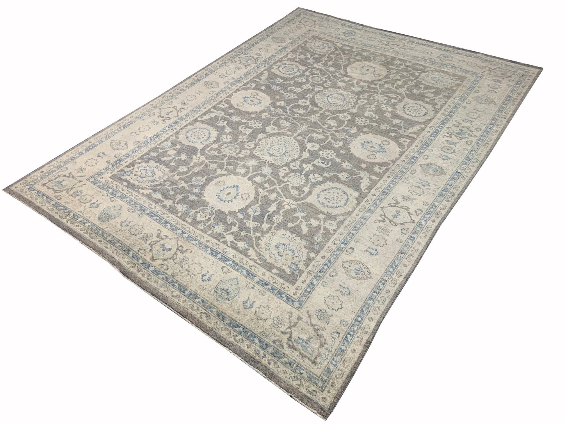 An Afghan Chobi rug featuring a traditional floral pattern in shades of grey, beige, and blue.