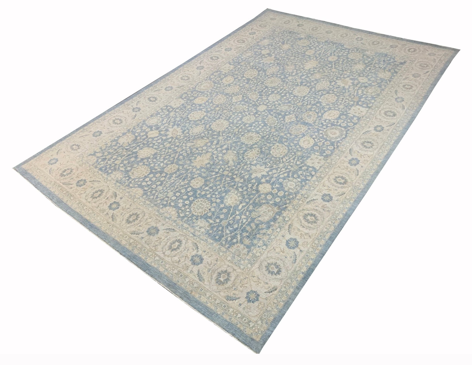 A handmade Afghan Balkh rug featuring a traditional floral pattern in shades of blue and cream.