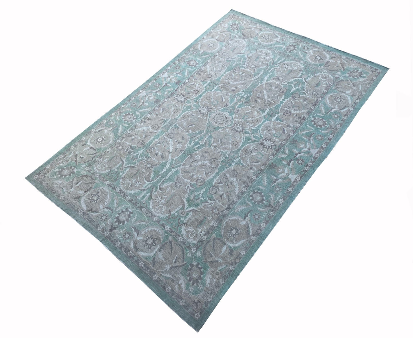 An Afghan Chobi rug featuring a traditional floral pattern in shades of teal and beige.