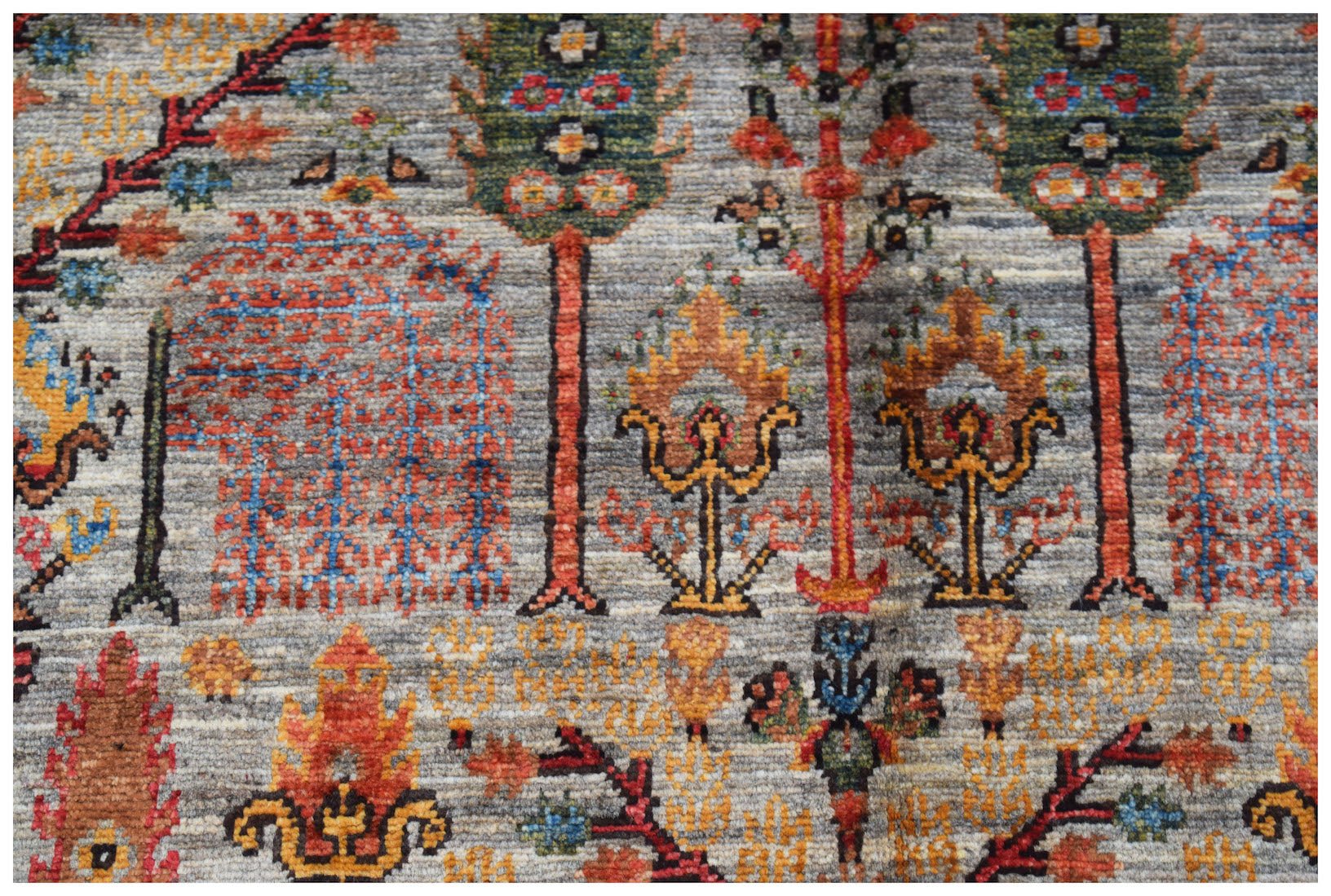Handwoven Afghan Chobi rug featuring a traditional Tree of Life pattern in earthy tones.