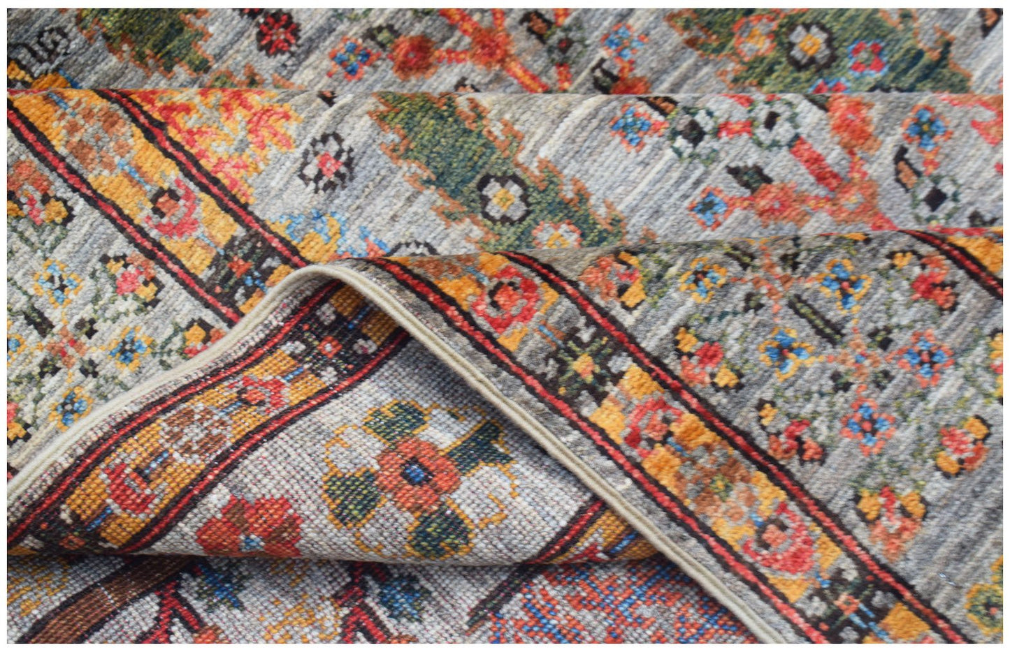 A handwoven Afghan Chobi rug featuring a traditional Tree of Life pattern in vibrant colors.