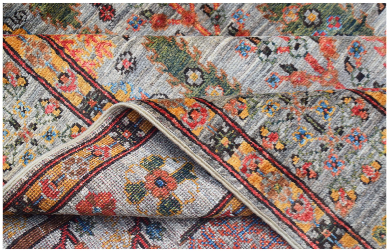 A handwoven Afghan Chobi rug featuring a traditional Tree of Life pattern in vibrant colors.