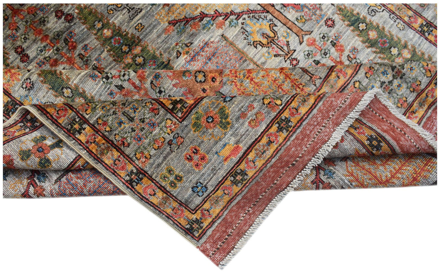 A handwoven Afghan Chobi rug featuring a traditional Tree of Life pattern in earthy tones.