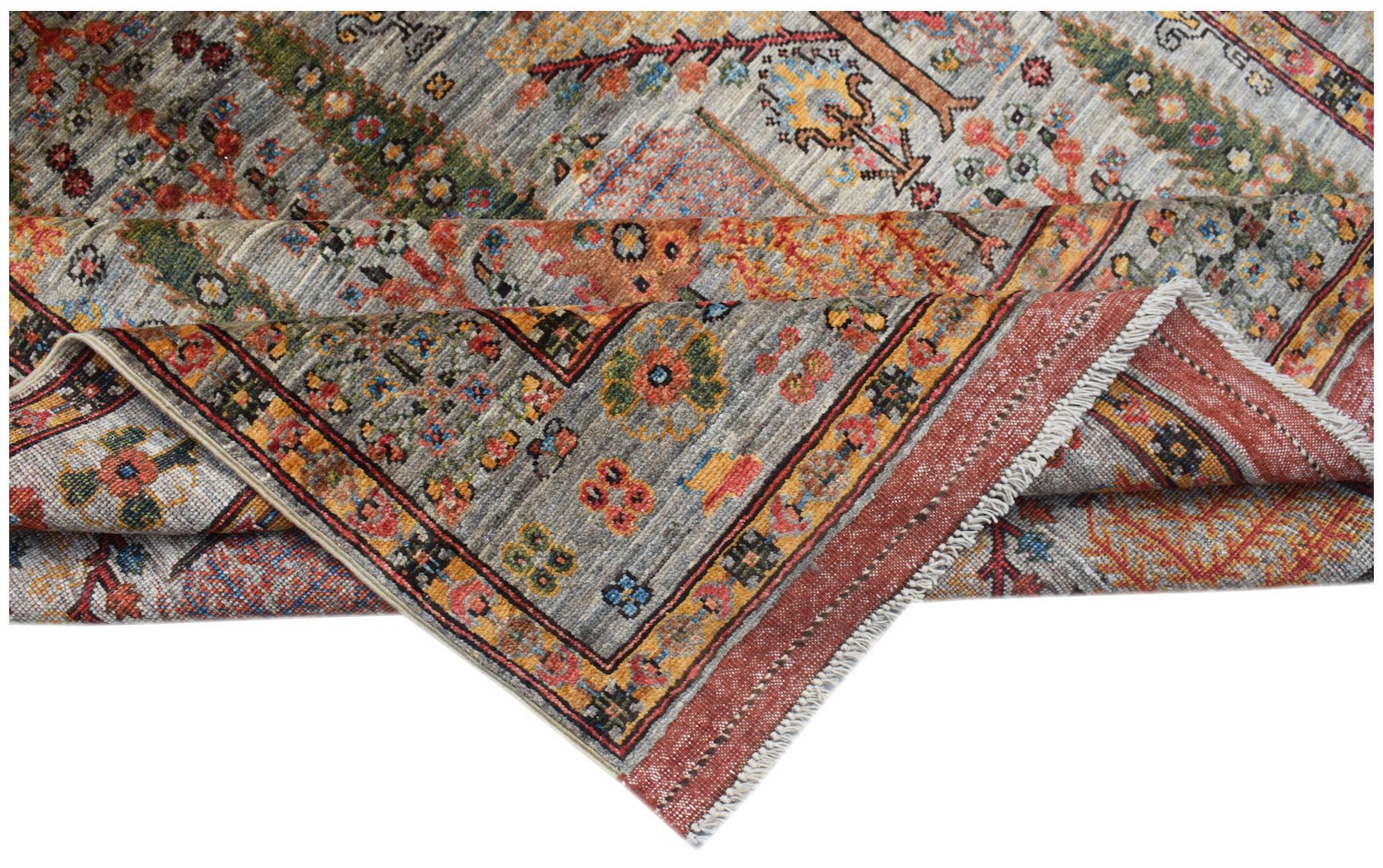 A handwoven Afghan Chobi rug featuring a traditional Tree of Life pattern in earthy tones.