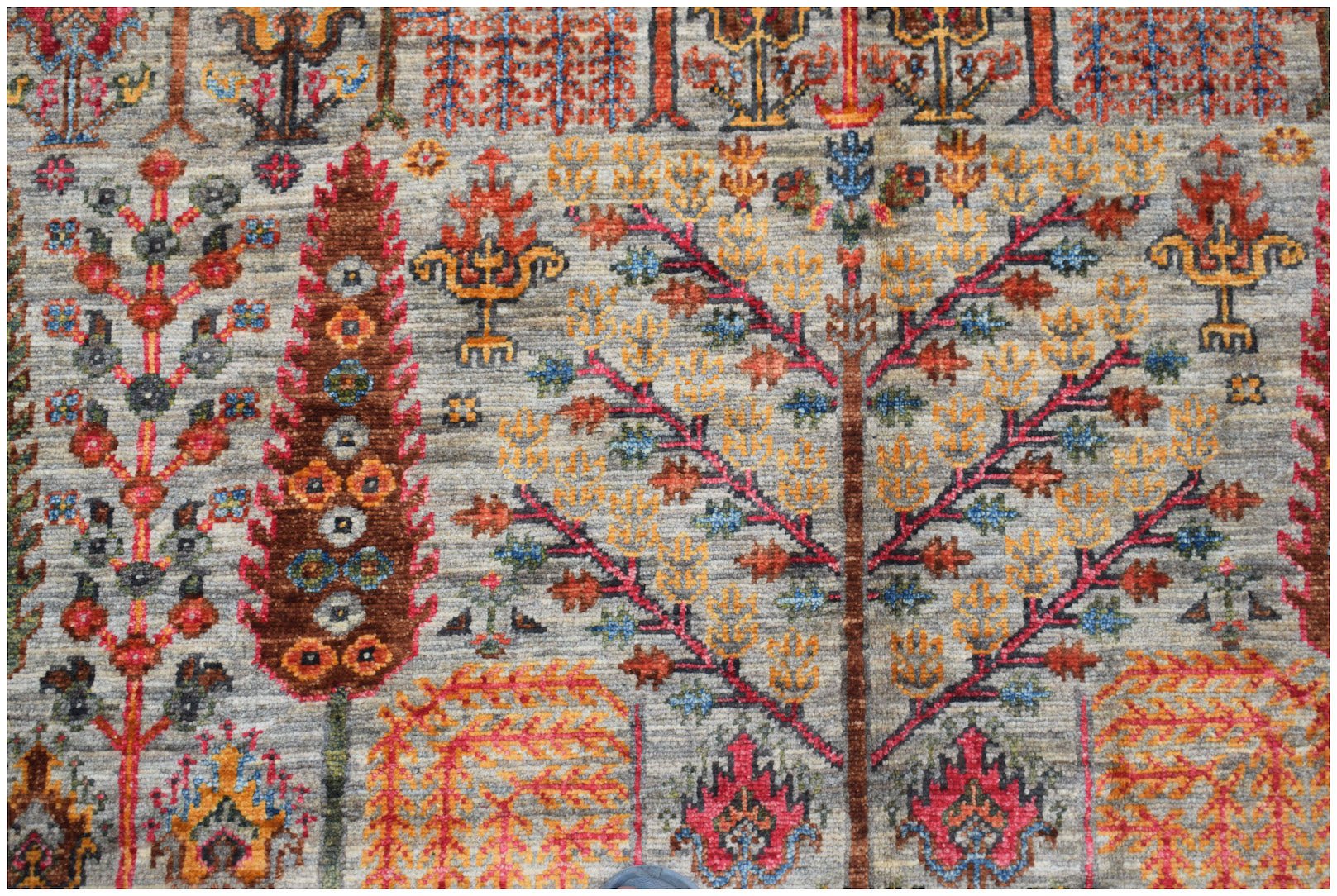 Handwoven Afghan Chobi rug featuring a traditional Tree of Life pattern in earthy tones.