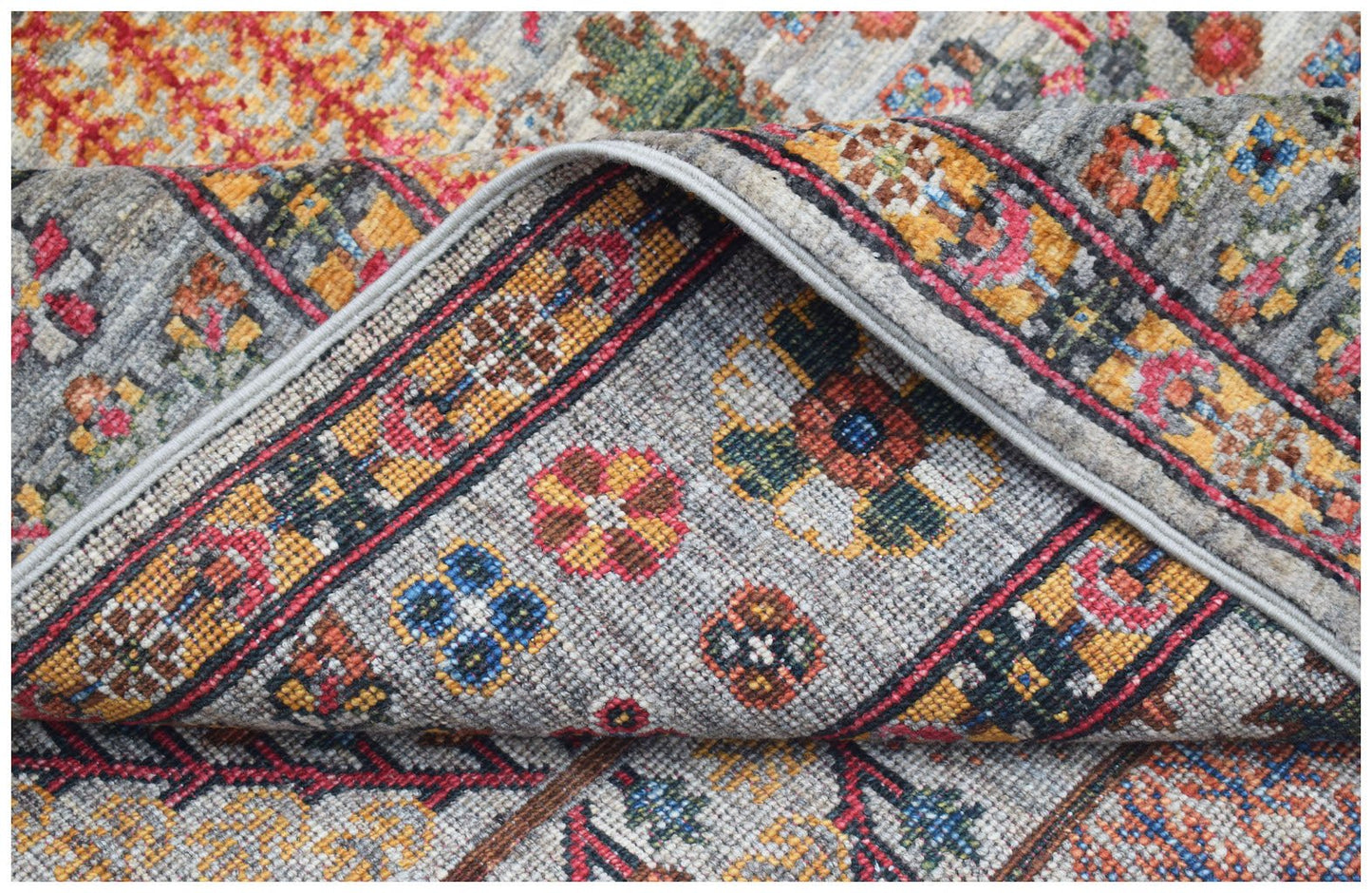 A handwoven Afghan Chobi rug featuring a traditional Tree of Life pattern in warm, earthy tones.
