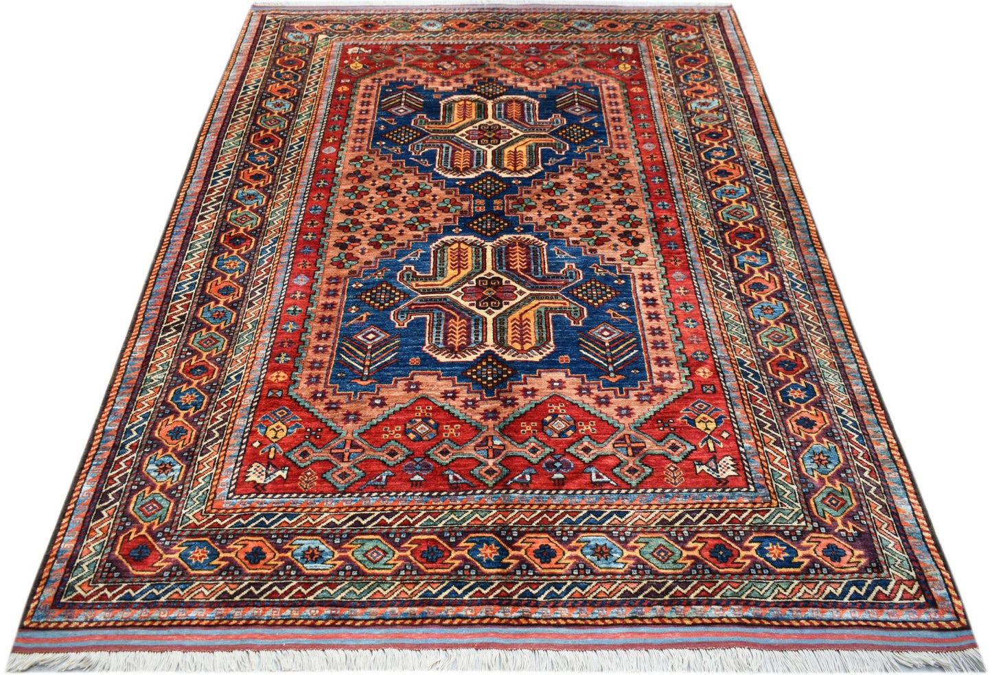 Handwoven Afghan Herati rug featuring a traditional geometric pattern in red and blue wool.