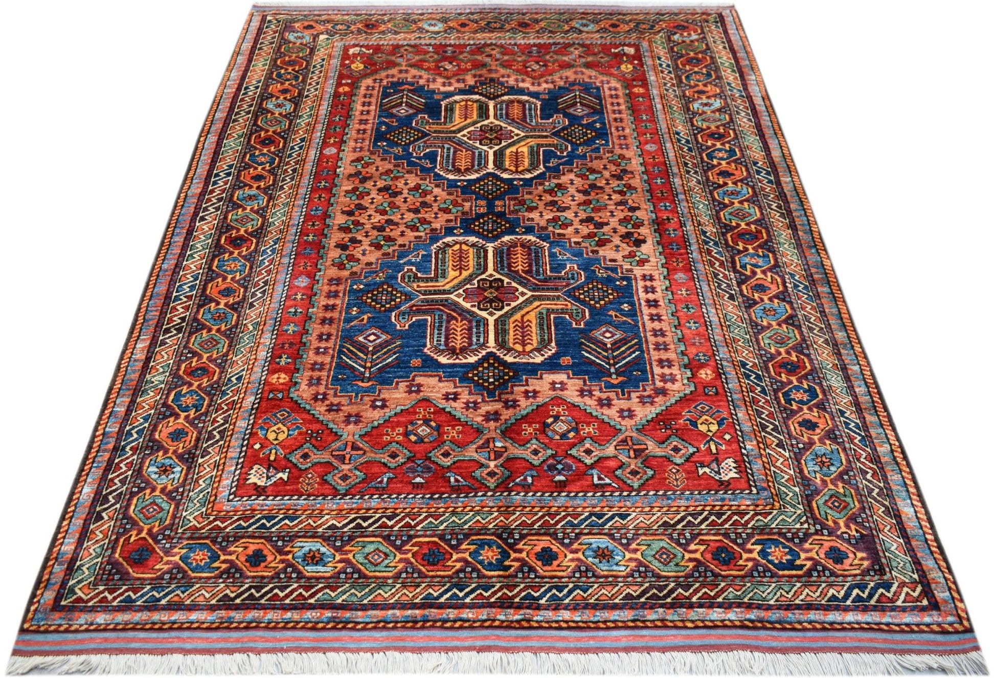 Handwoven Afghan Herati rug featuring a traditional geometric pattern in red and blue wool.