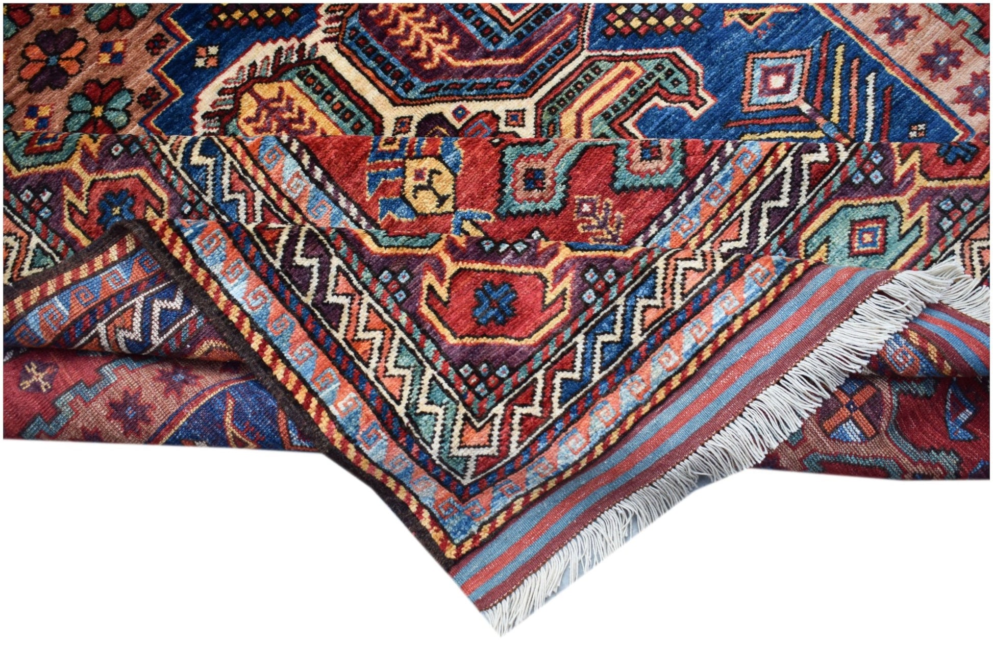 A handwoven Afghan Herati rug featuring intricate geometric patterns in red, blue, and gold tones.