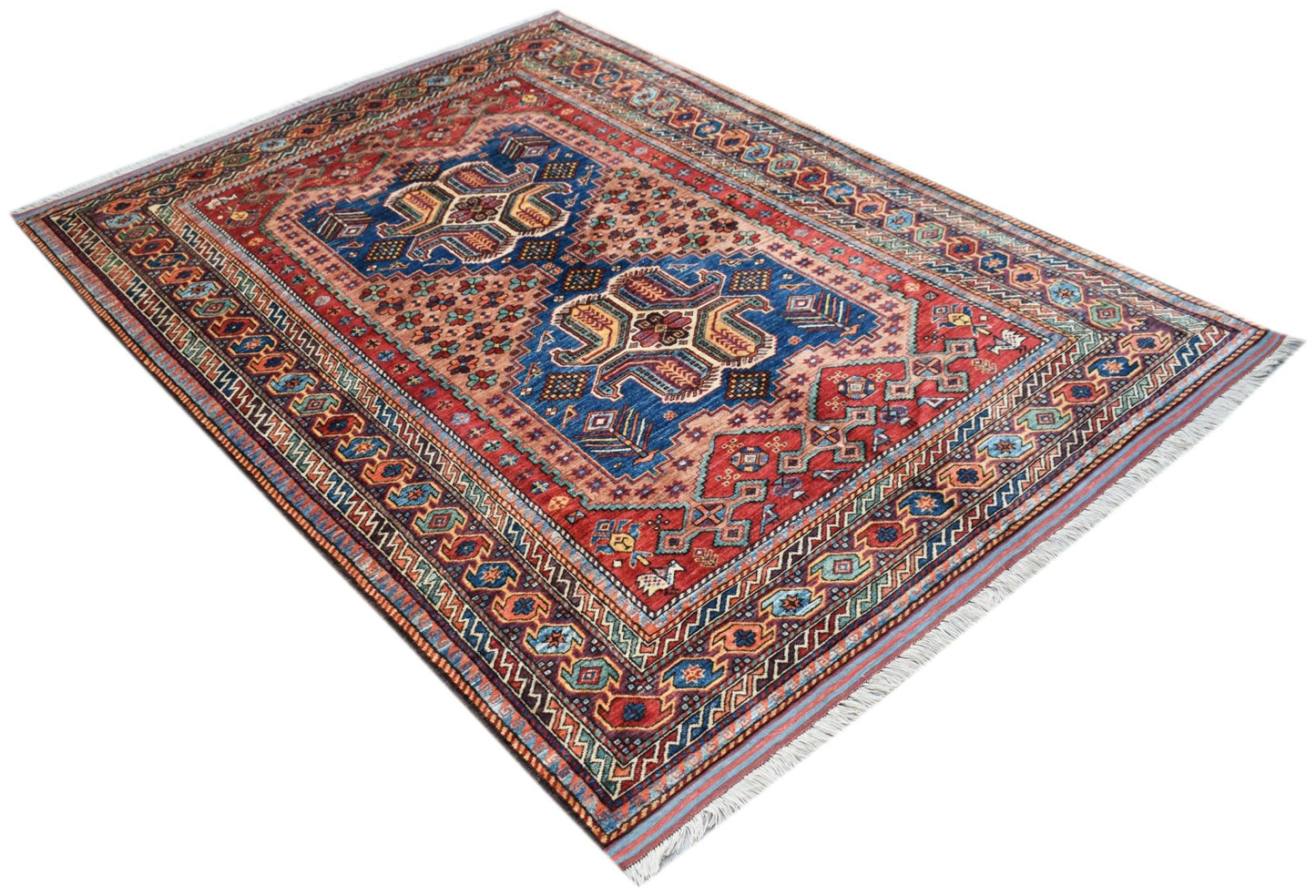 An Afghan Herati rug featuring a traditional geometric pattern in red, blue, and cream tones.