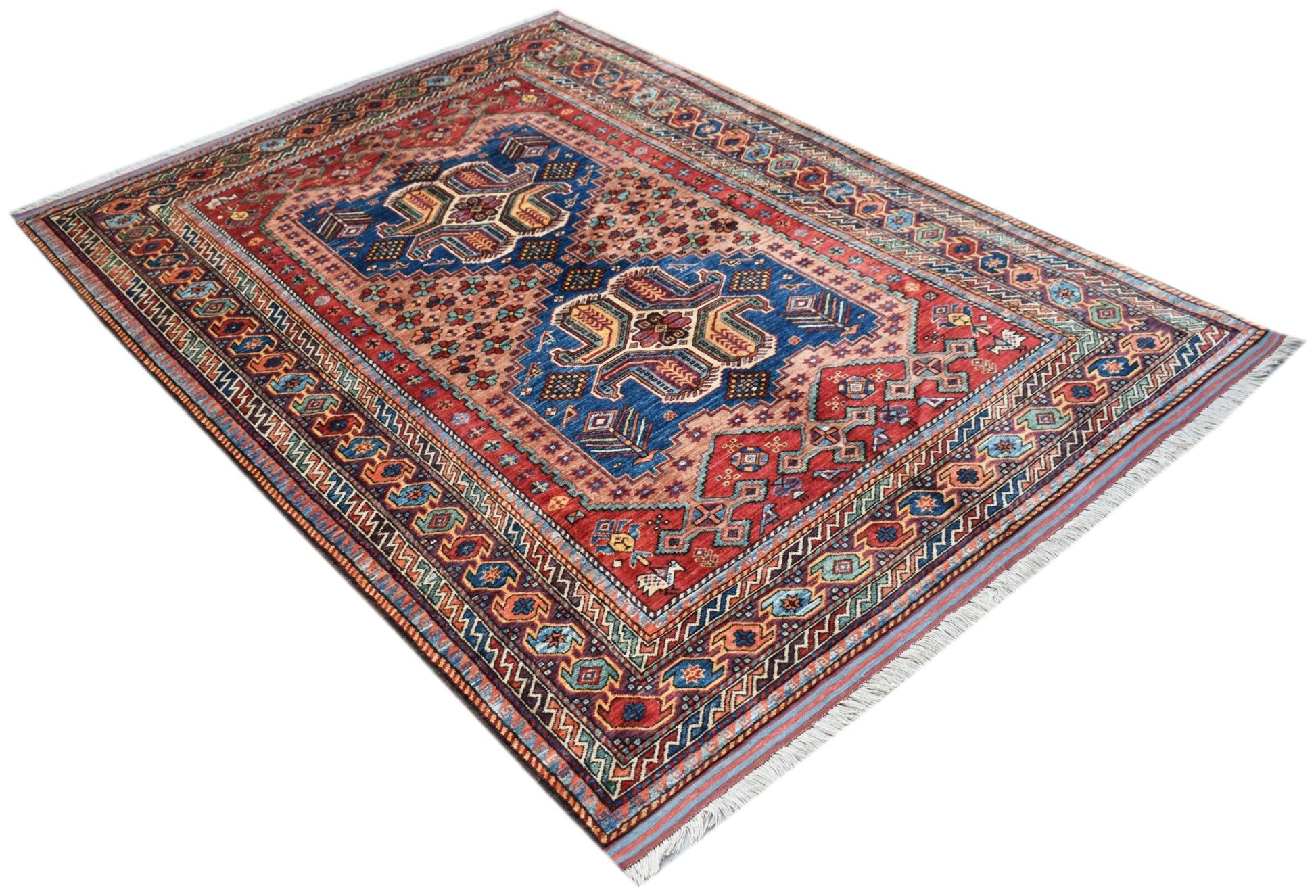 An Afghan Herati rug featuring a traditional geometric pattern in red, blue, and cream tones.