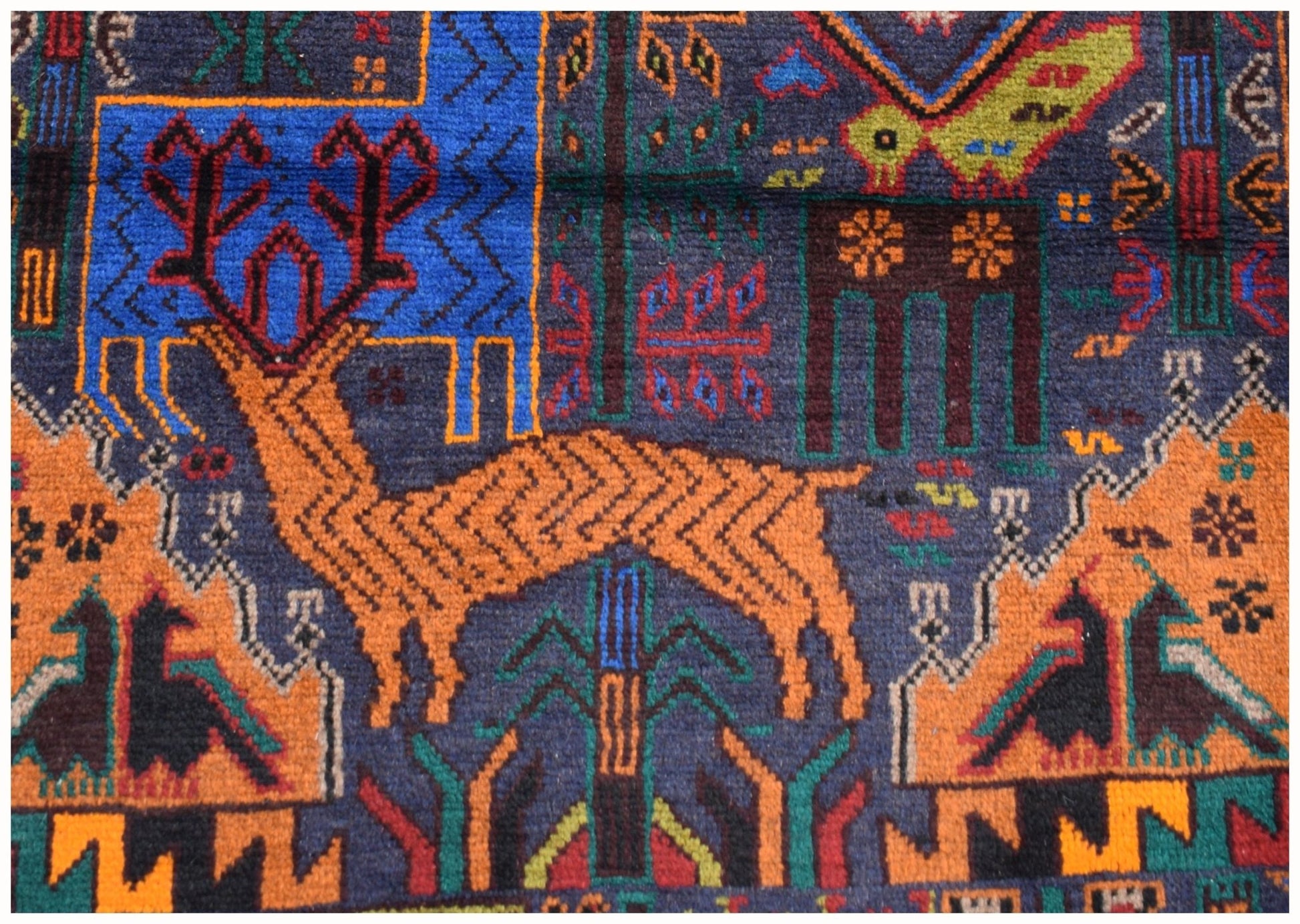 Handmade Afghan wool runner rug featuring a colorful hunting scene with deer and birds.